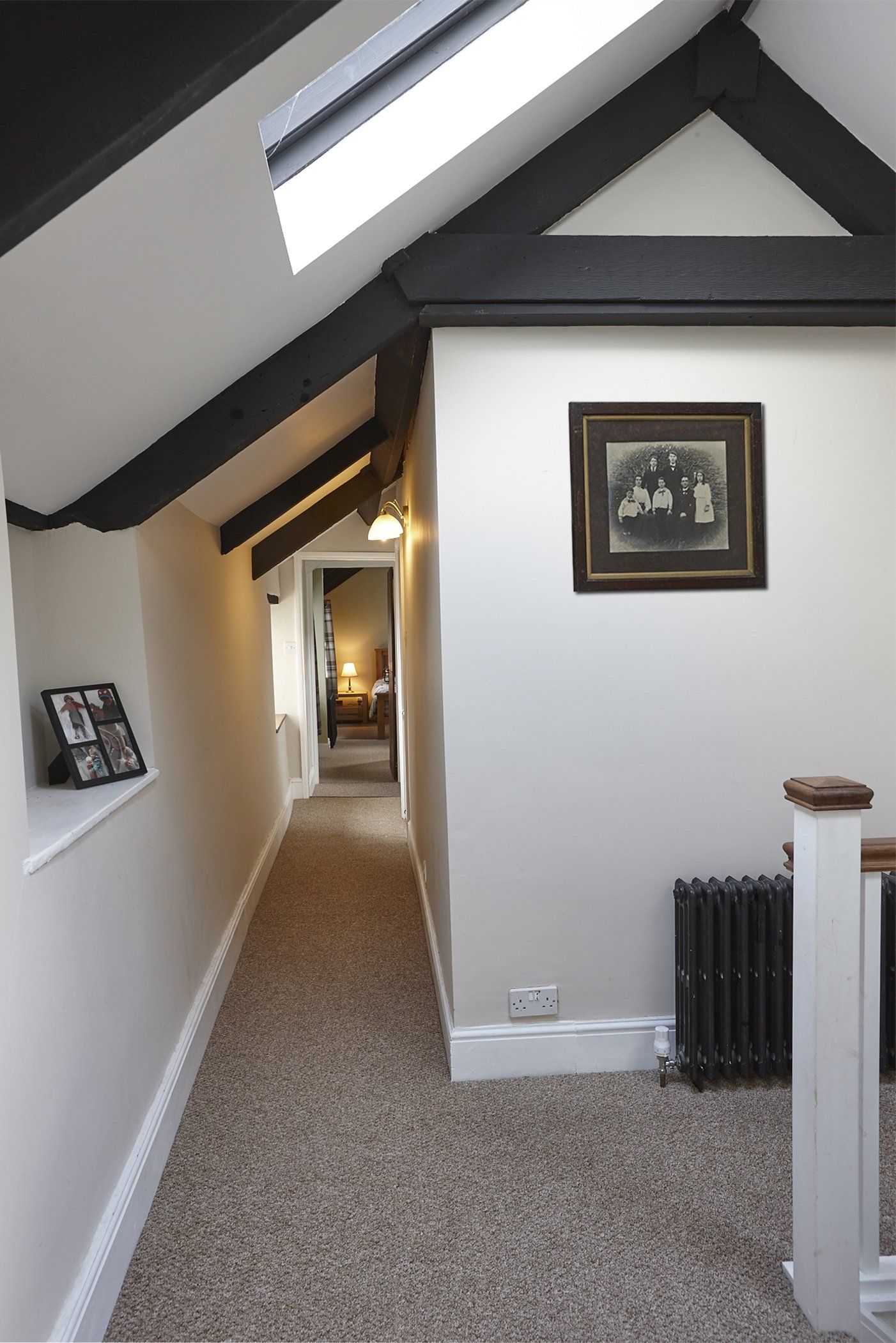 A long hallway with a picture on the wall