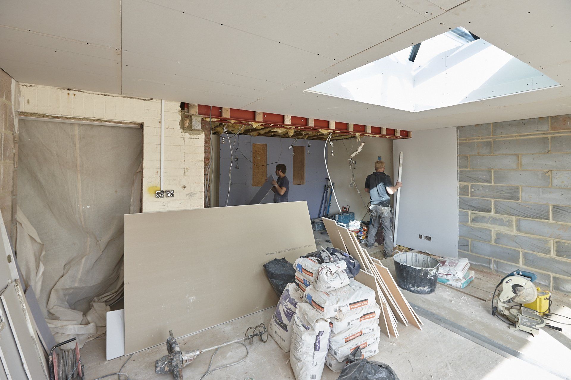 A room under construction with a skylight in the ceiling