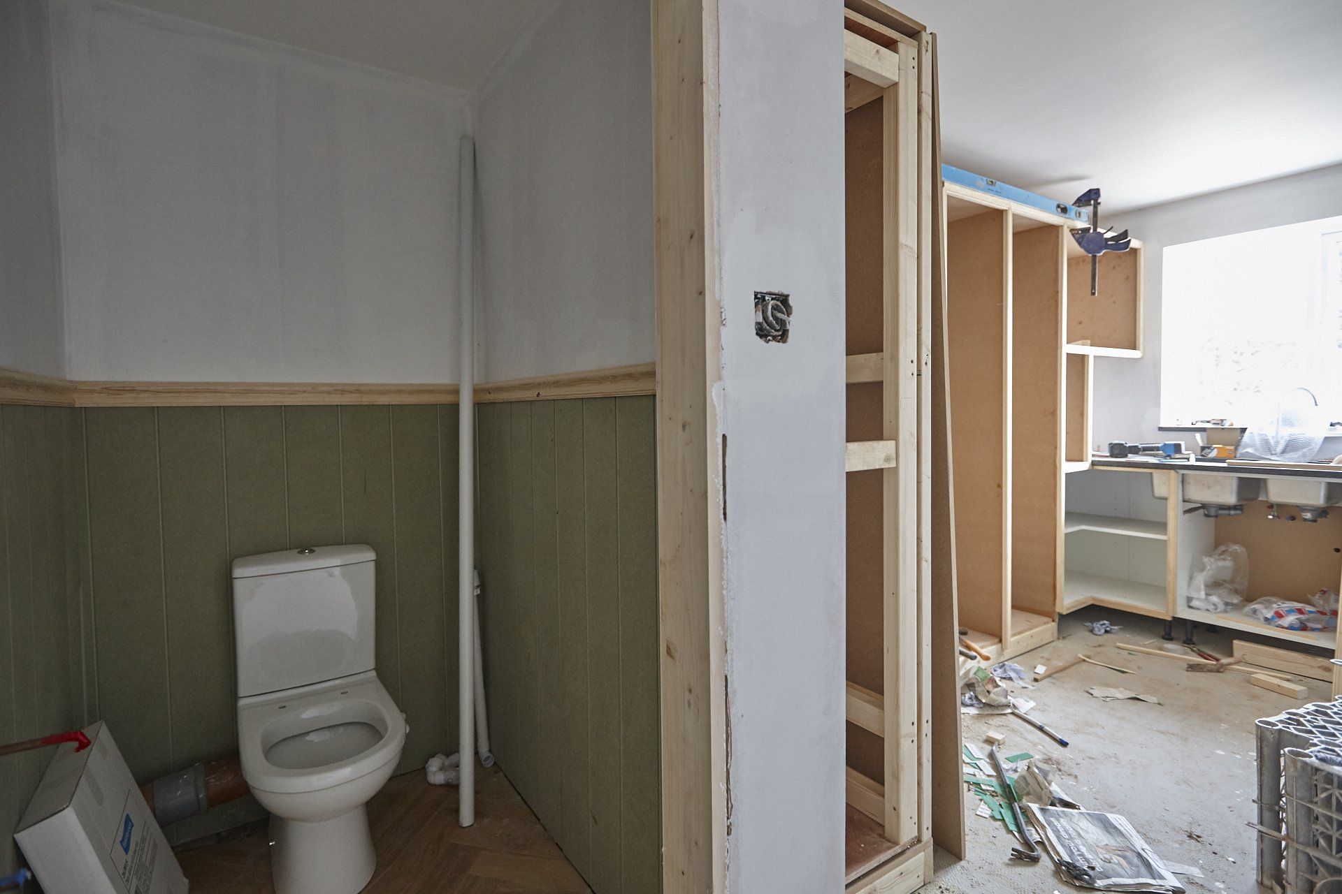 A bathroom under construction with a toilet and cabinets.