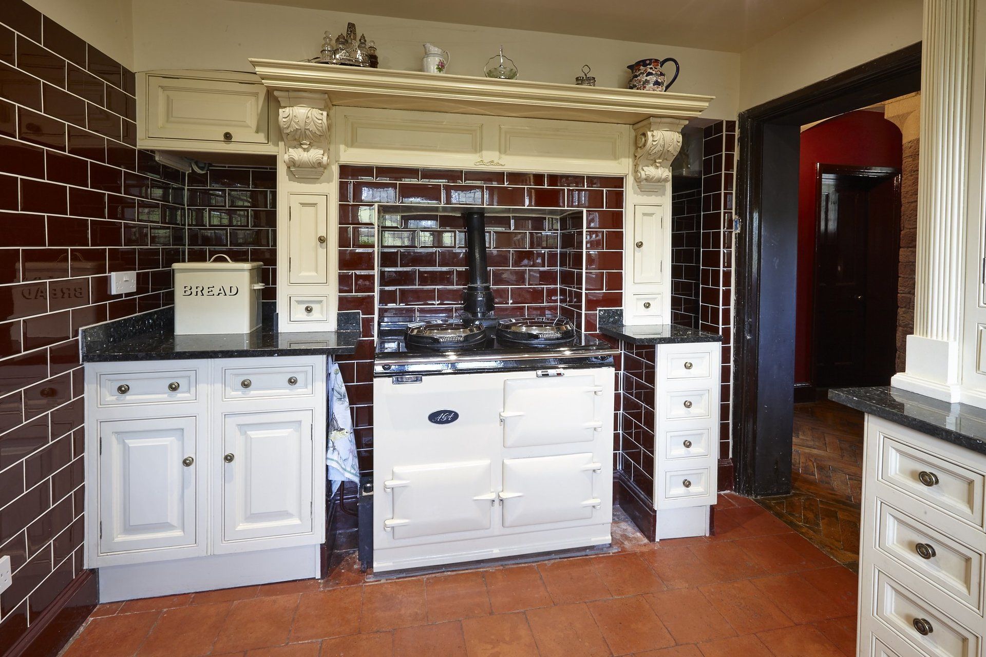 A kitchen with white cabinets and a white stove