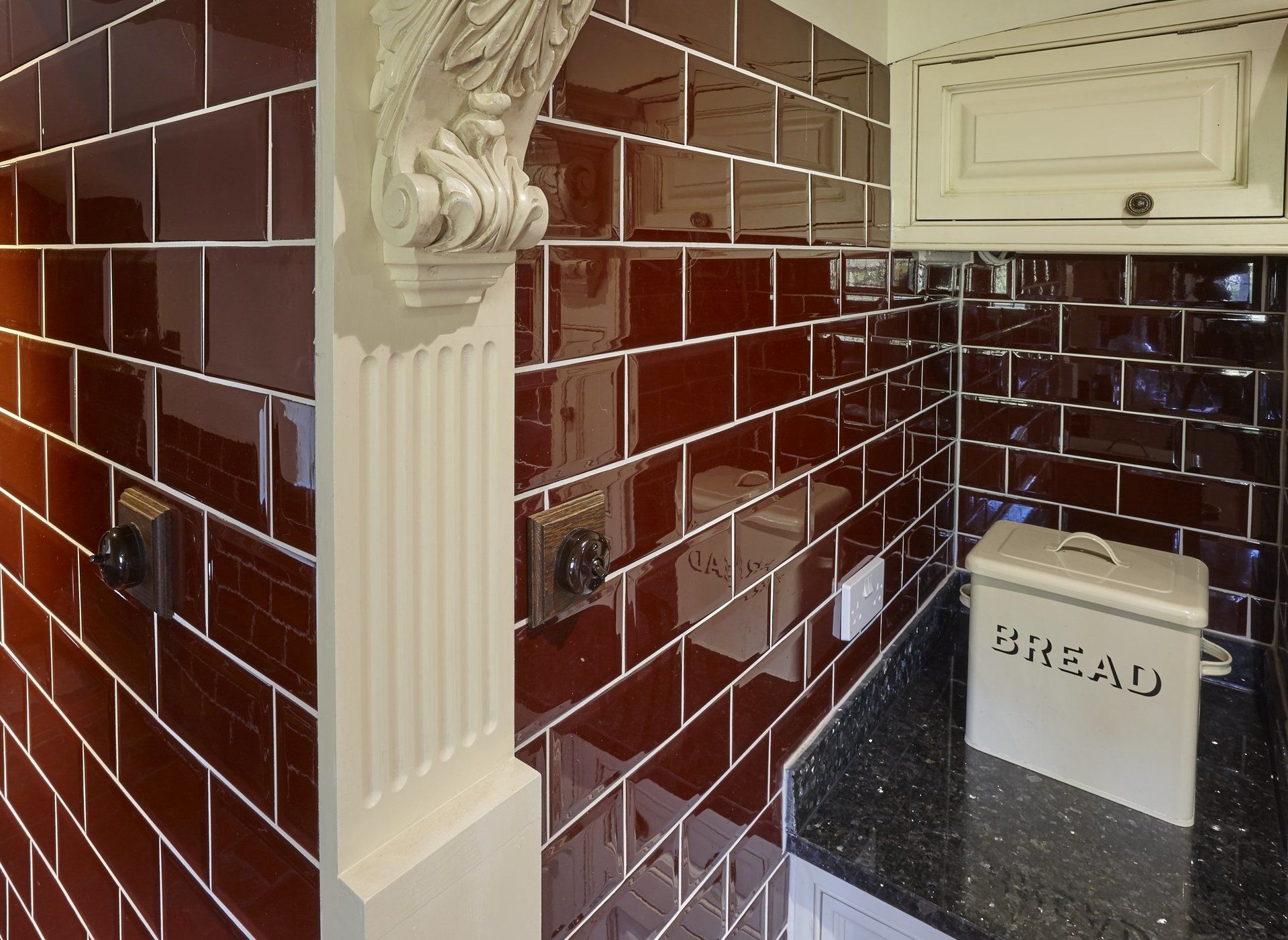 A kitchen with a bread box on the counter