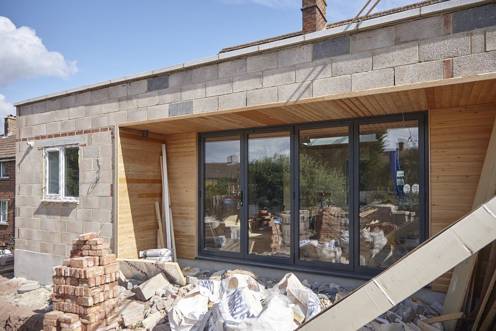 A house is being built with a lot of windows and bricks.