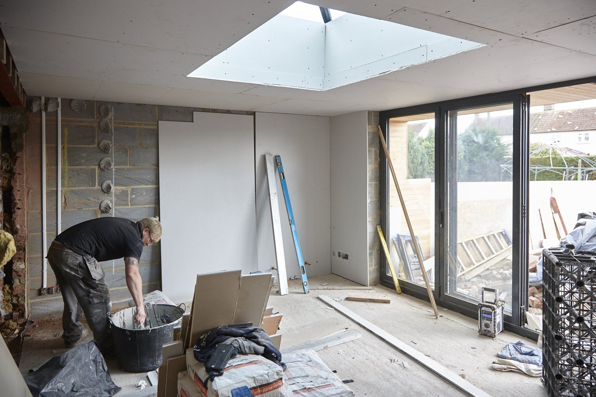 A man is working in a room with a skylight.
