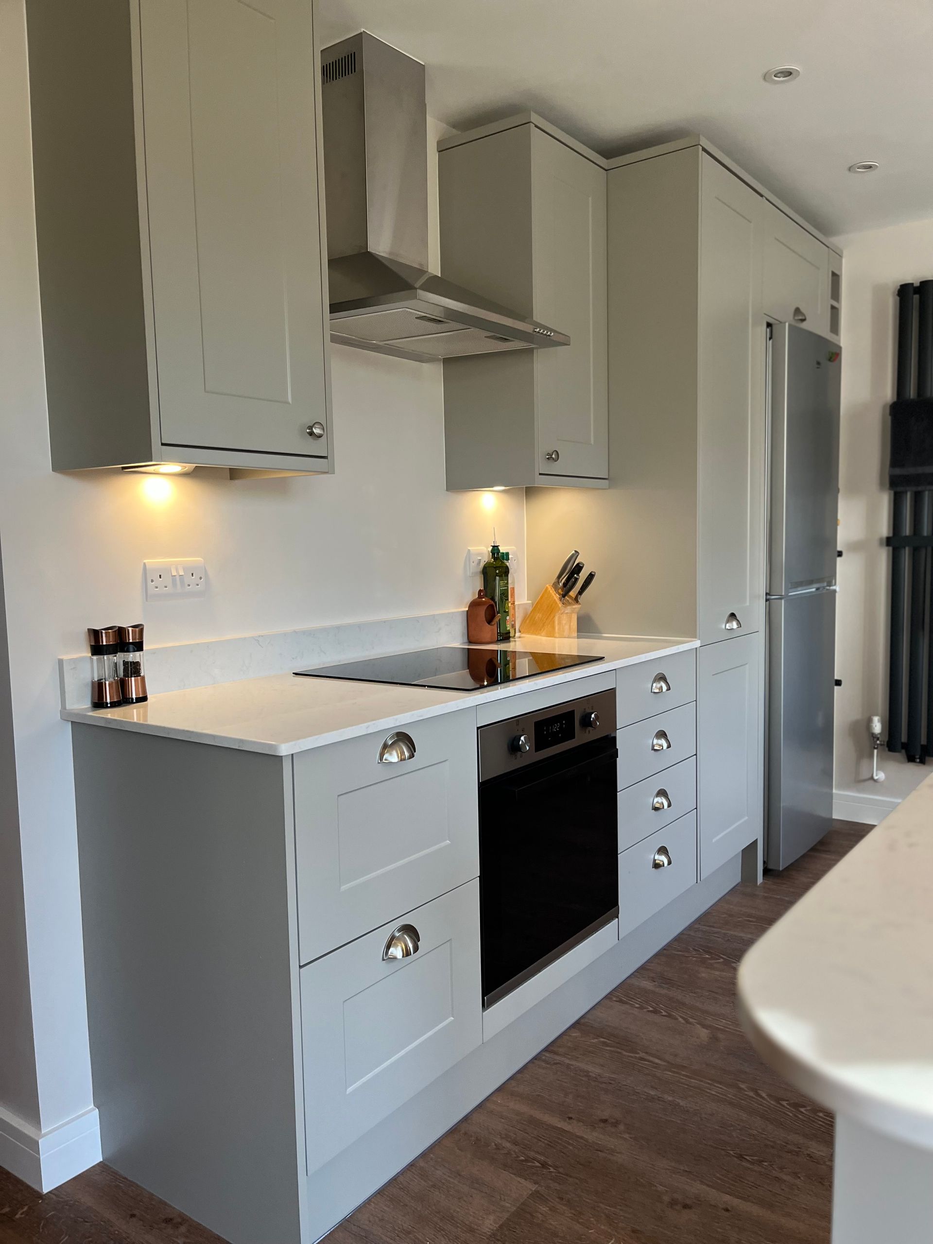 A kitchen with white cabinets and stainless steel appliances