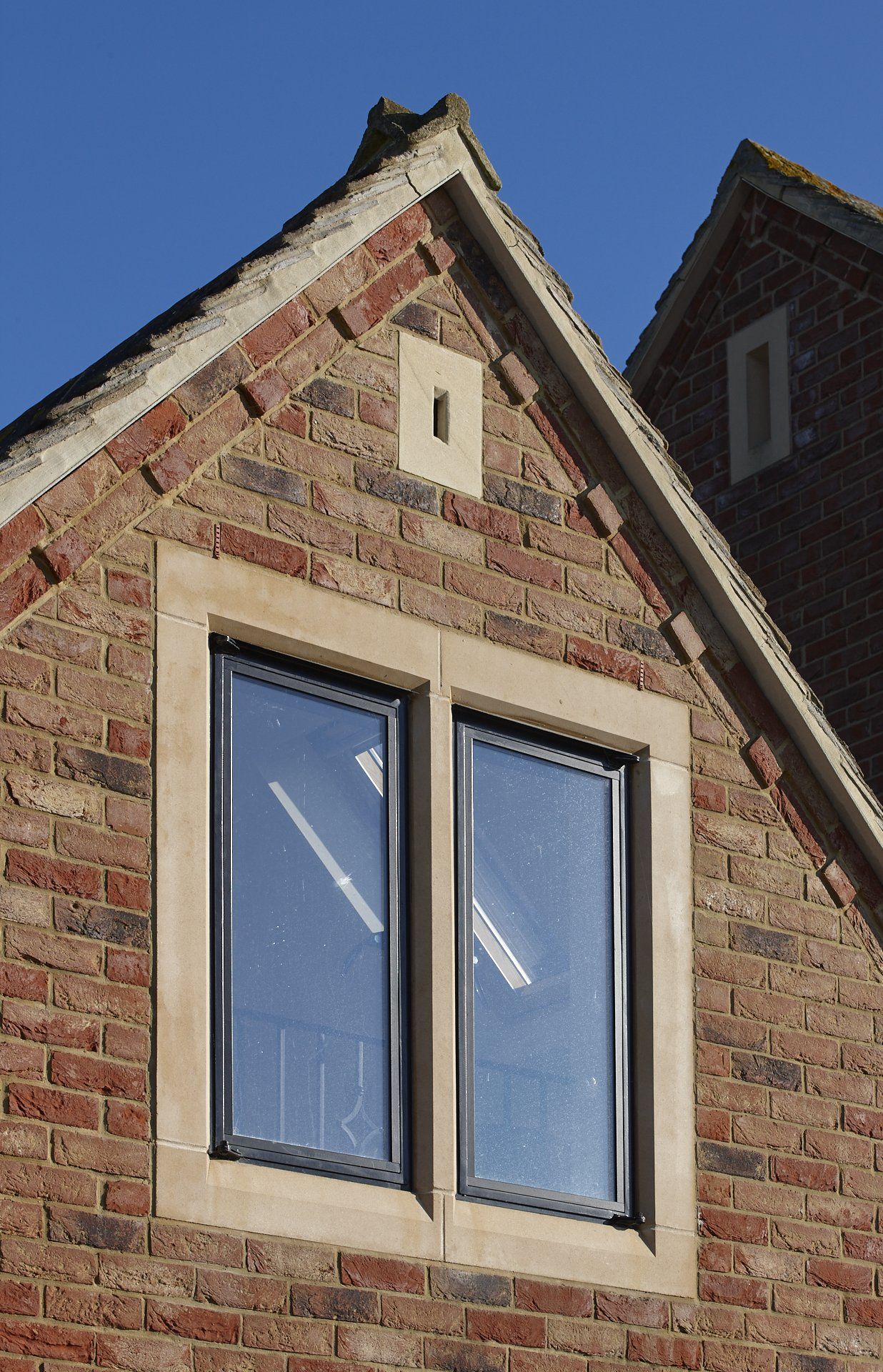 A brick building with a clock on the top of it