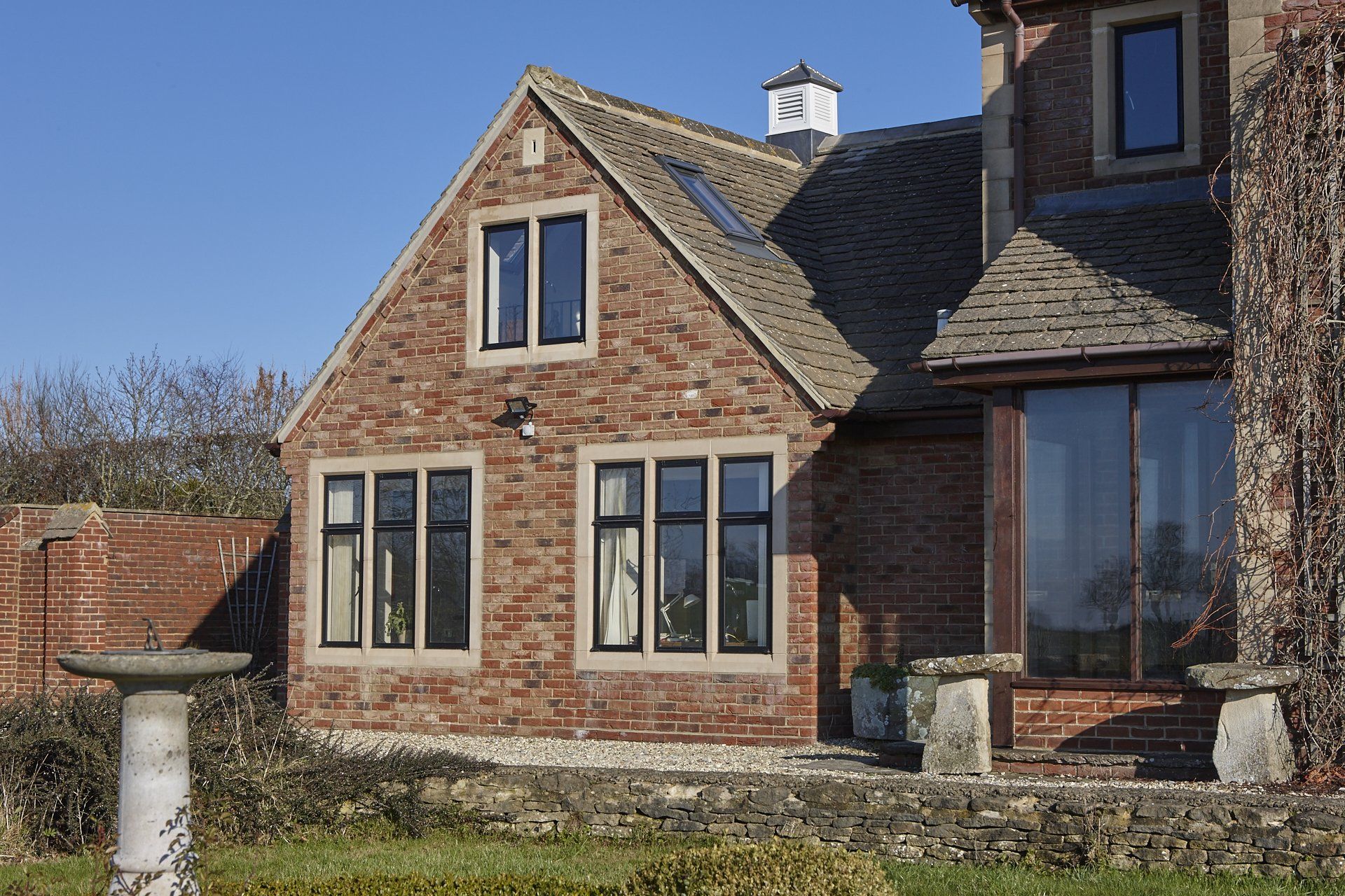 A large brick house with many windows and a chimney