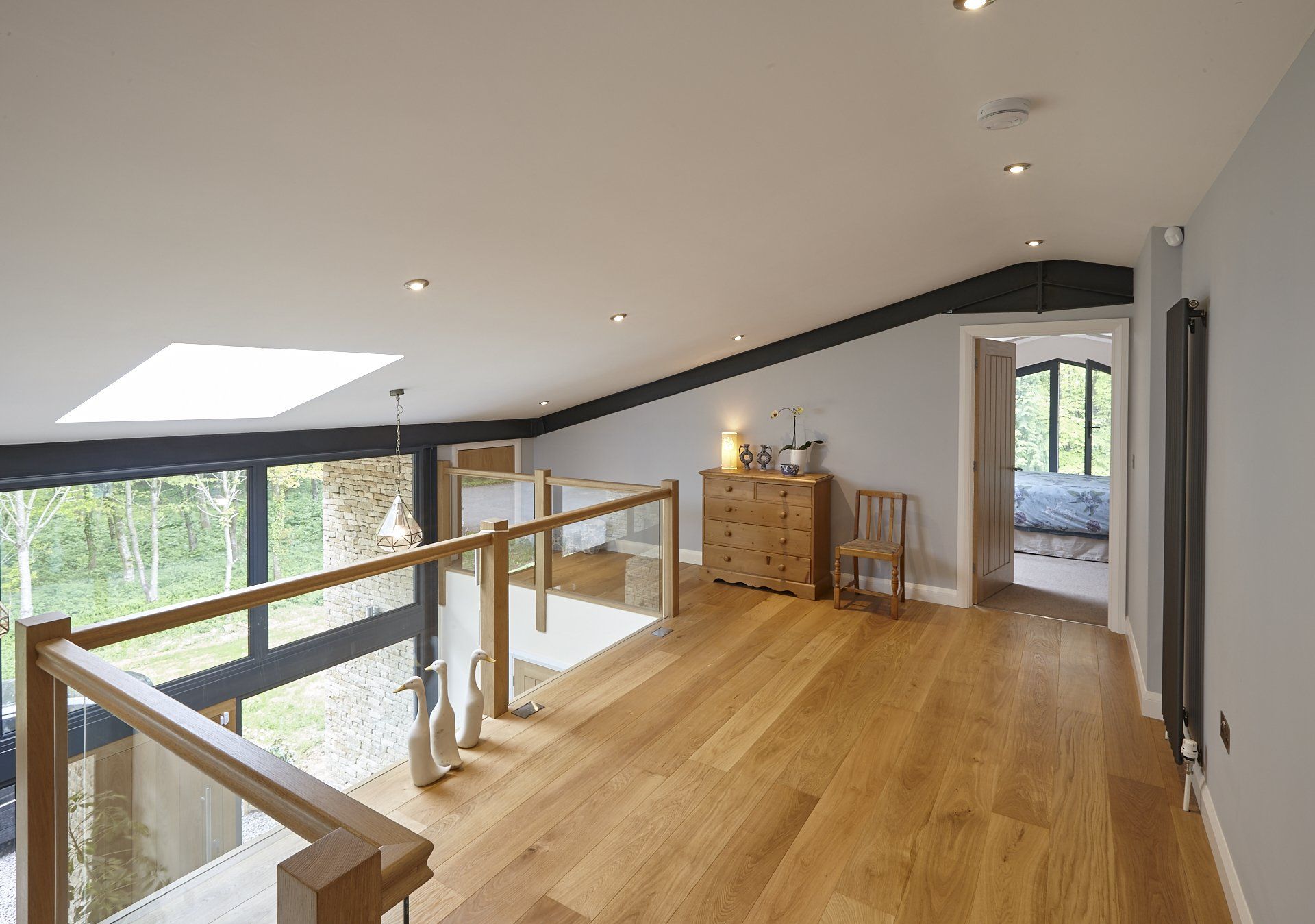 A room with hardwood floors and a skylight in the ceiling.