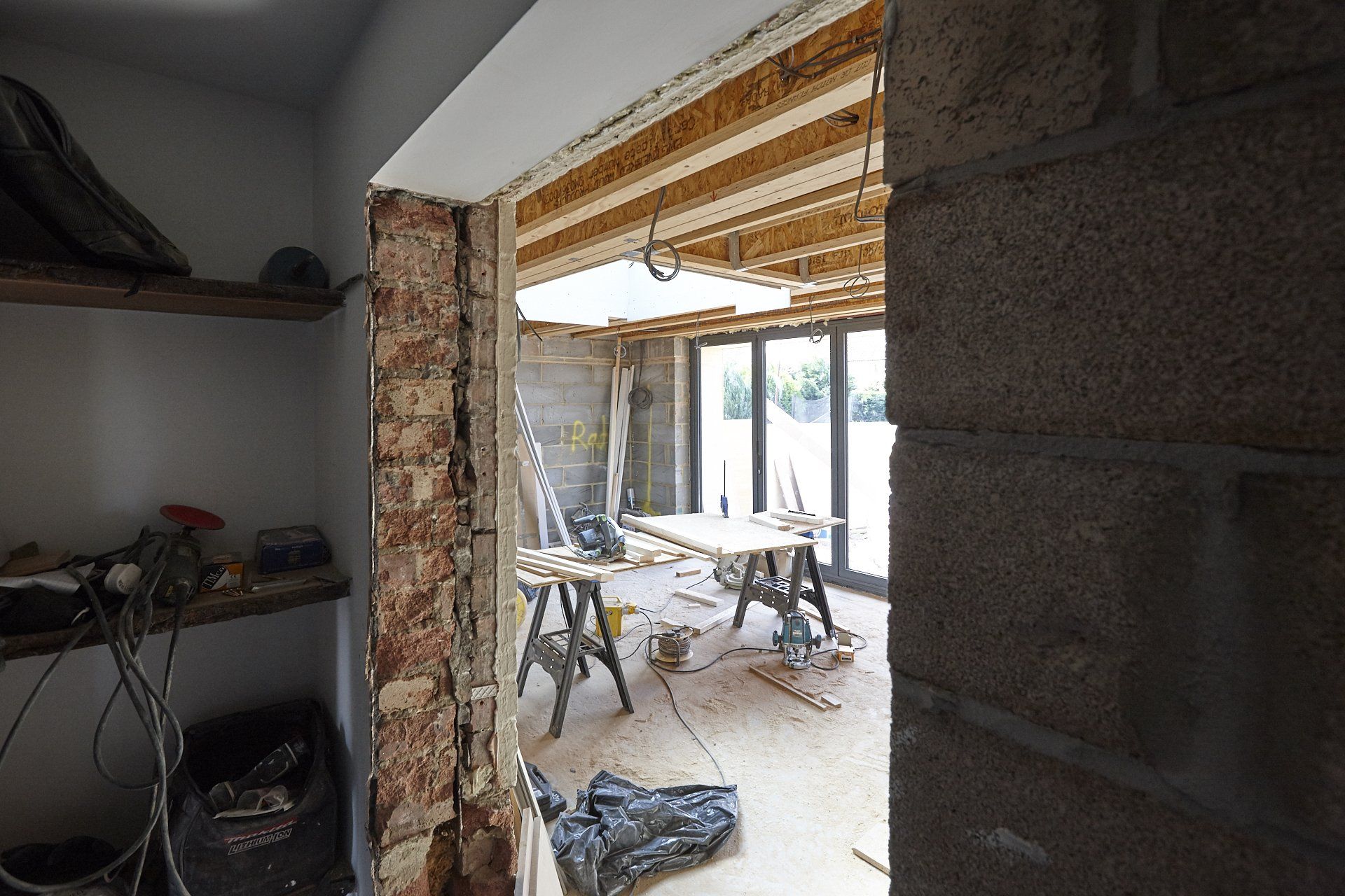 A room with a brick wall and a wooden table in it.