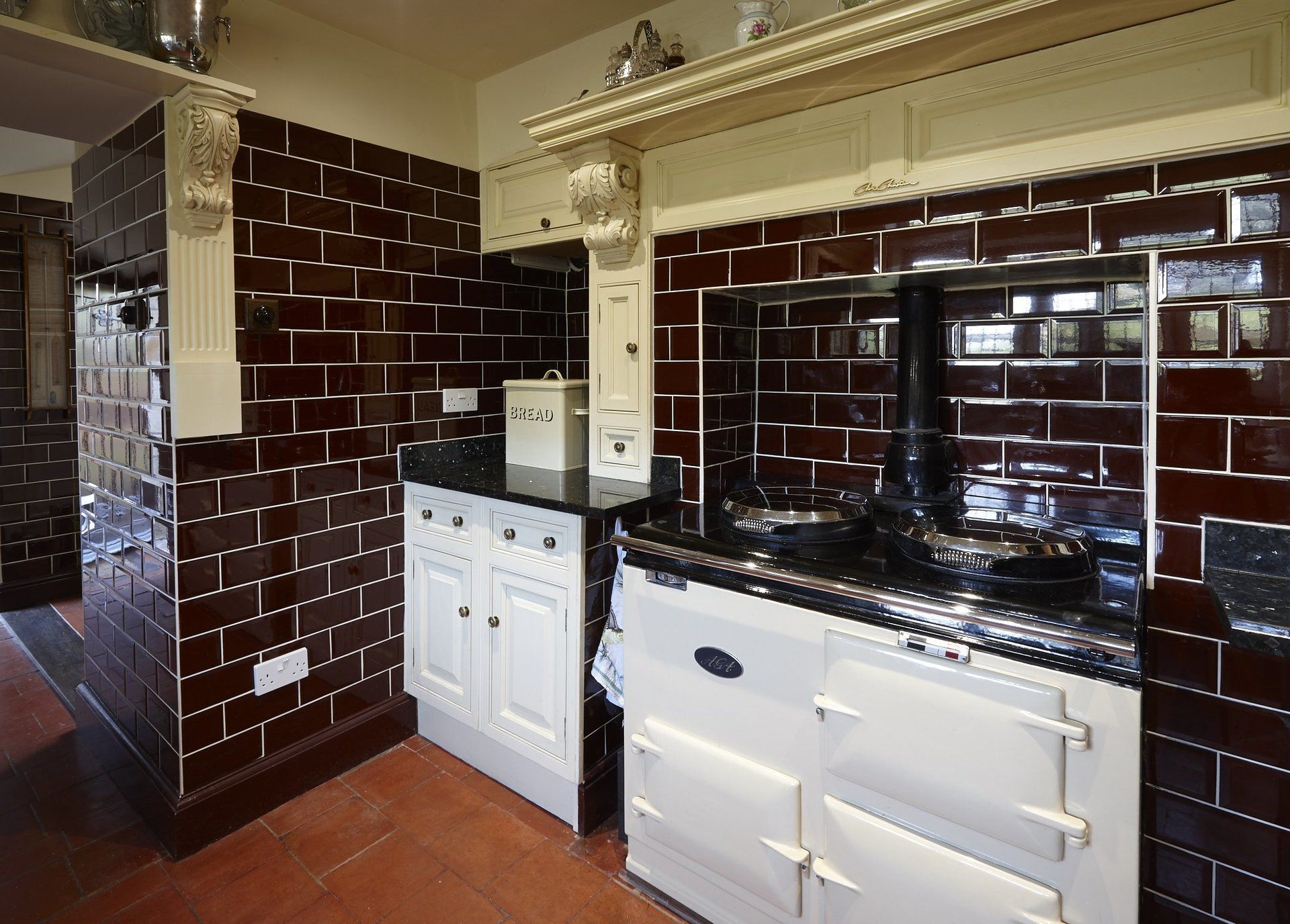 A kitchen with brick walls and a white stove