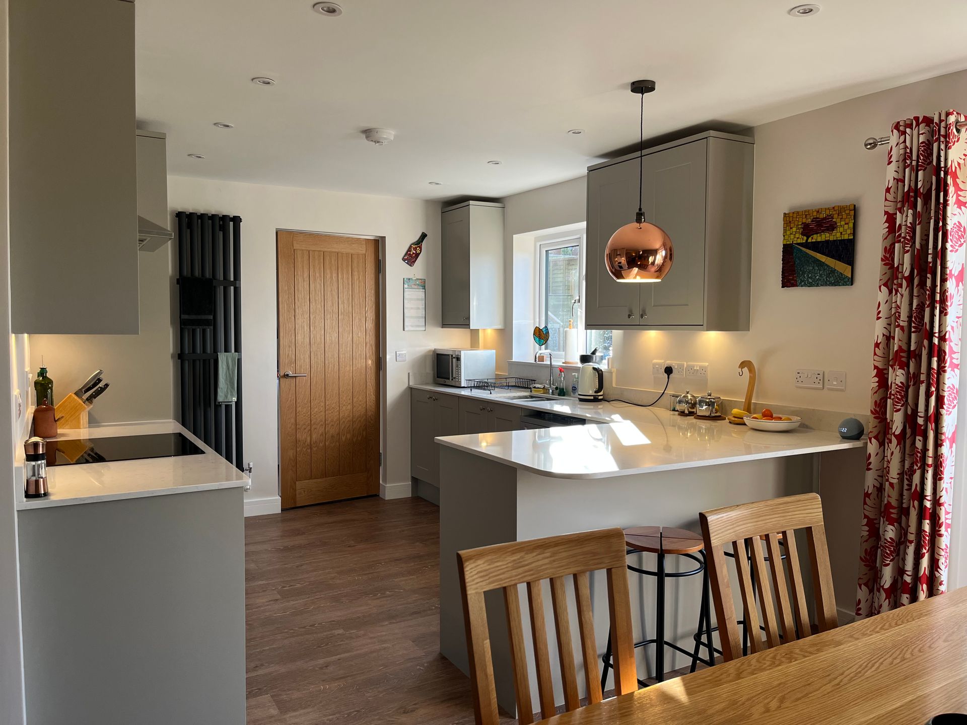A kitchen with a dining table and chairs in it.