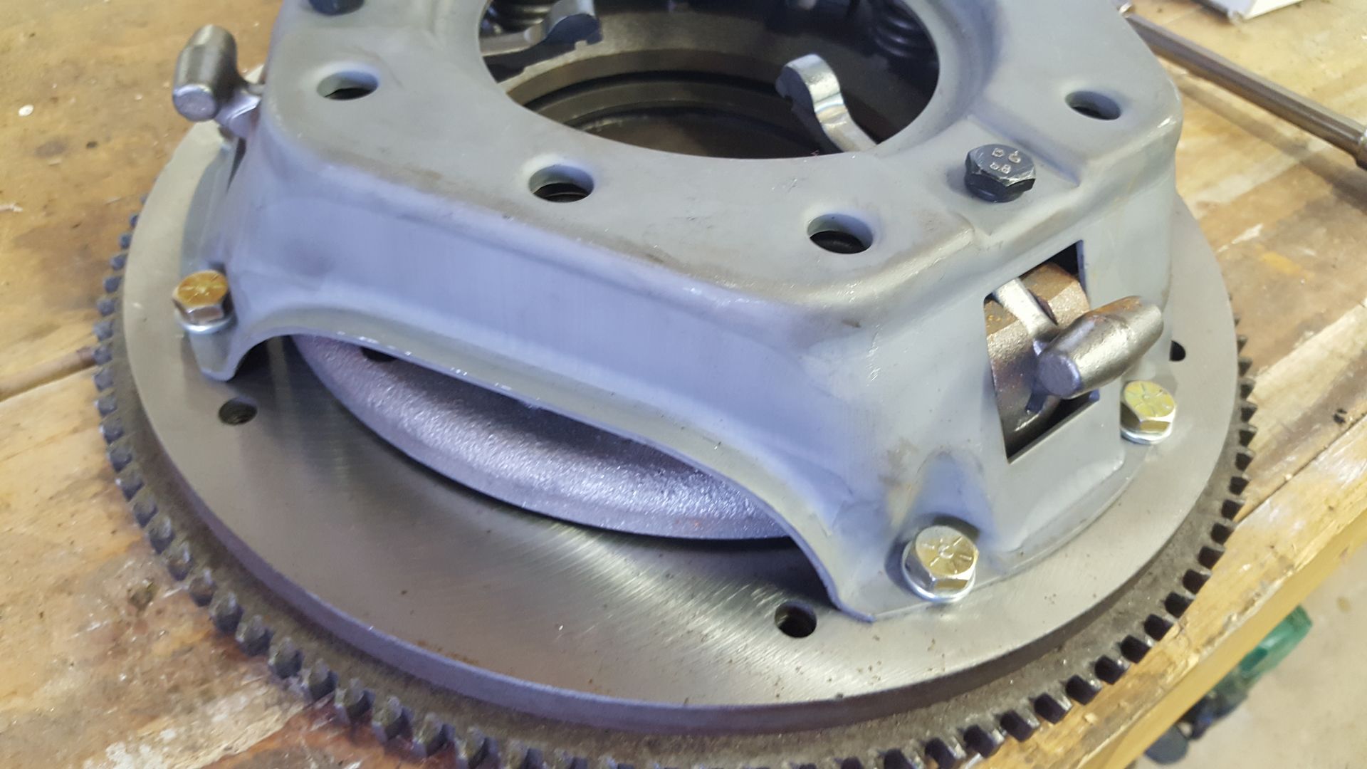 A close up of a clutch on a wooden table.