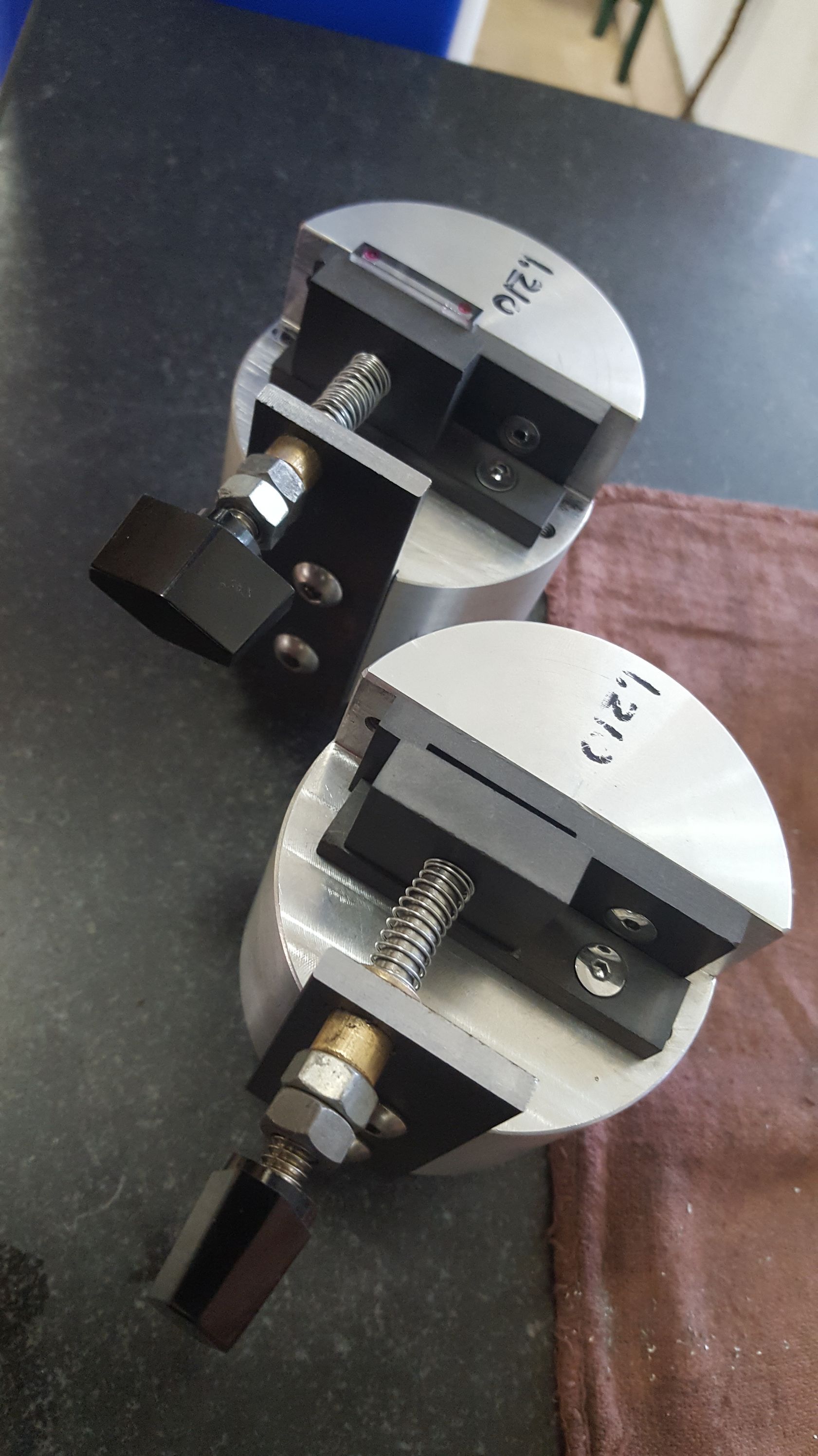 Two pieces of metal are sitting on top of each other on a table.