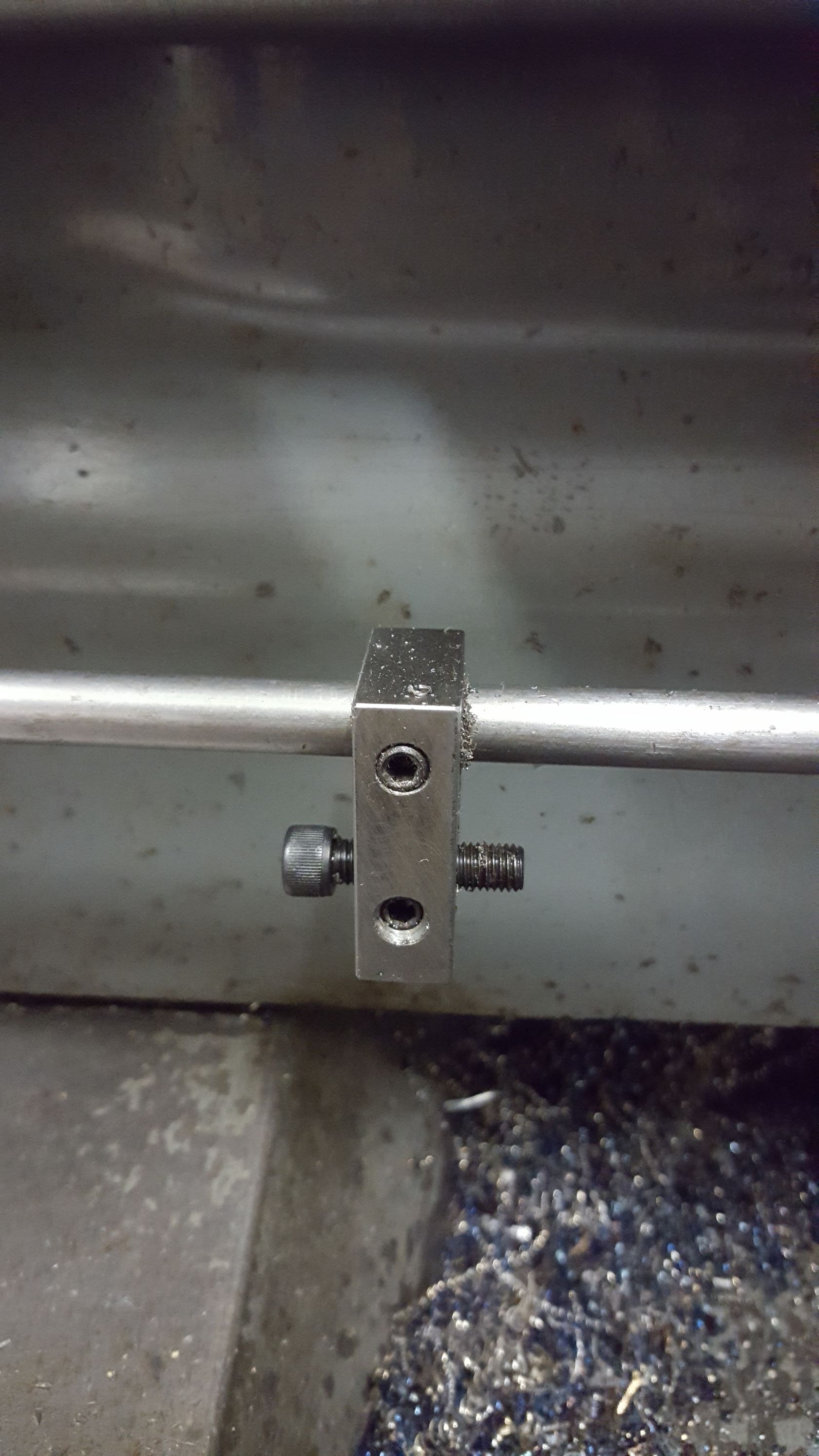 A metal pipe is sitting on top of a metal surface.