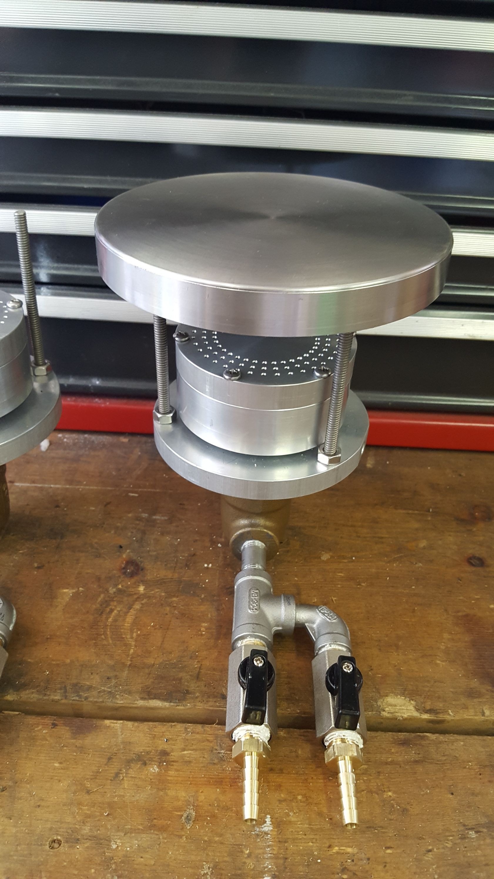 A metal object is sitting on top of a wooden table.