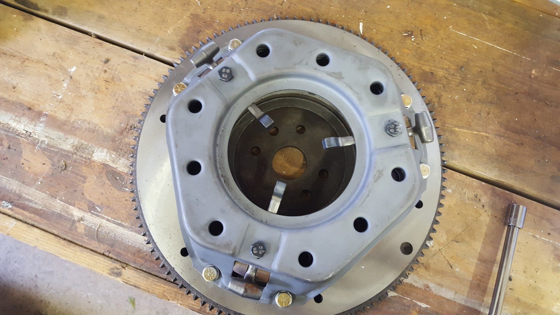A close up of a clutch plate on a wooden table