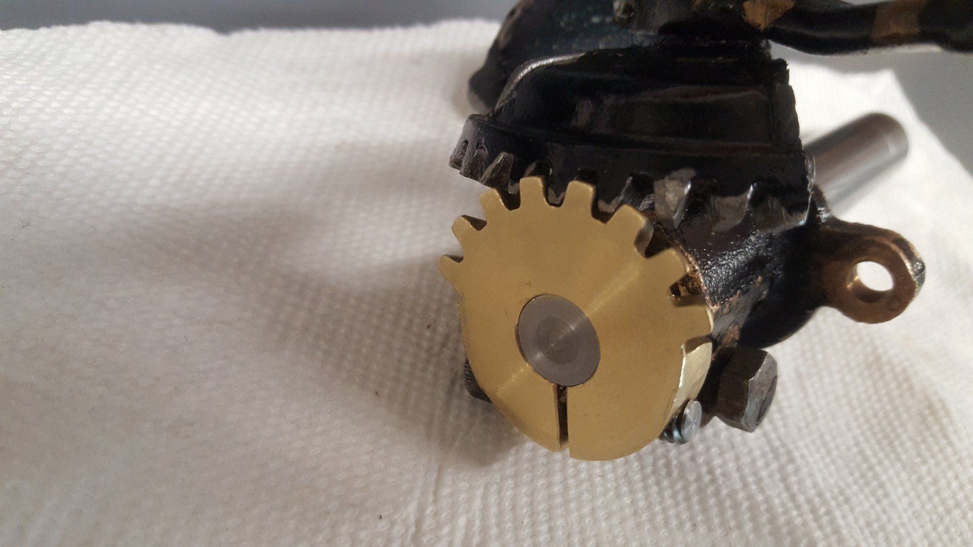 A close up of a gear on a white cloth