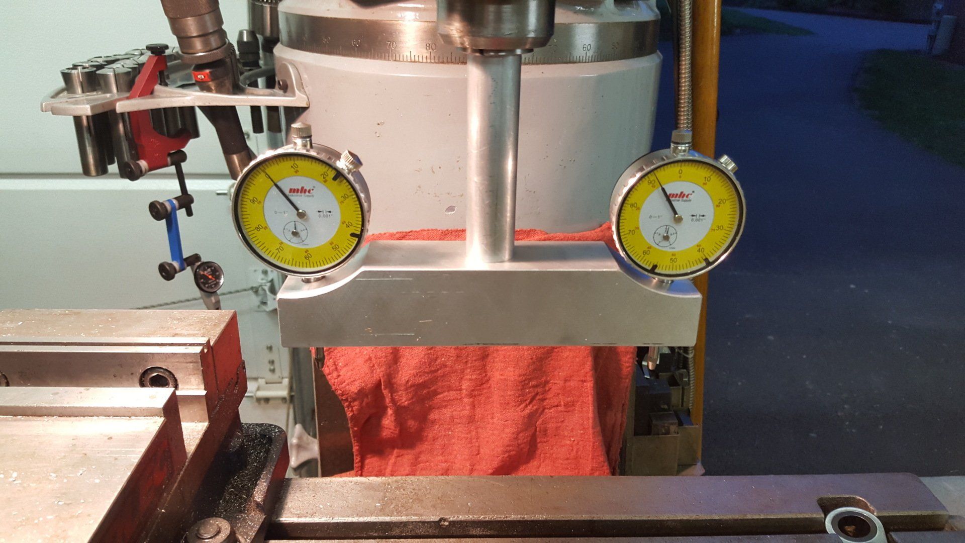 A pair of dial gauges are sitting on top of a machine
