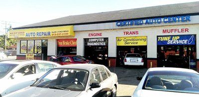 A lot of cars are parked in front of an auto repair shop