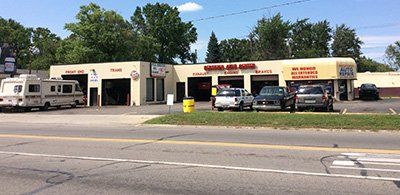 A rv is parked in front of a tire shop.