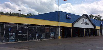A blue and yellow building with a flag on top of it.