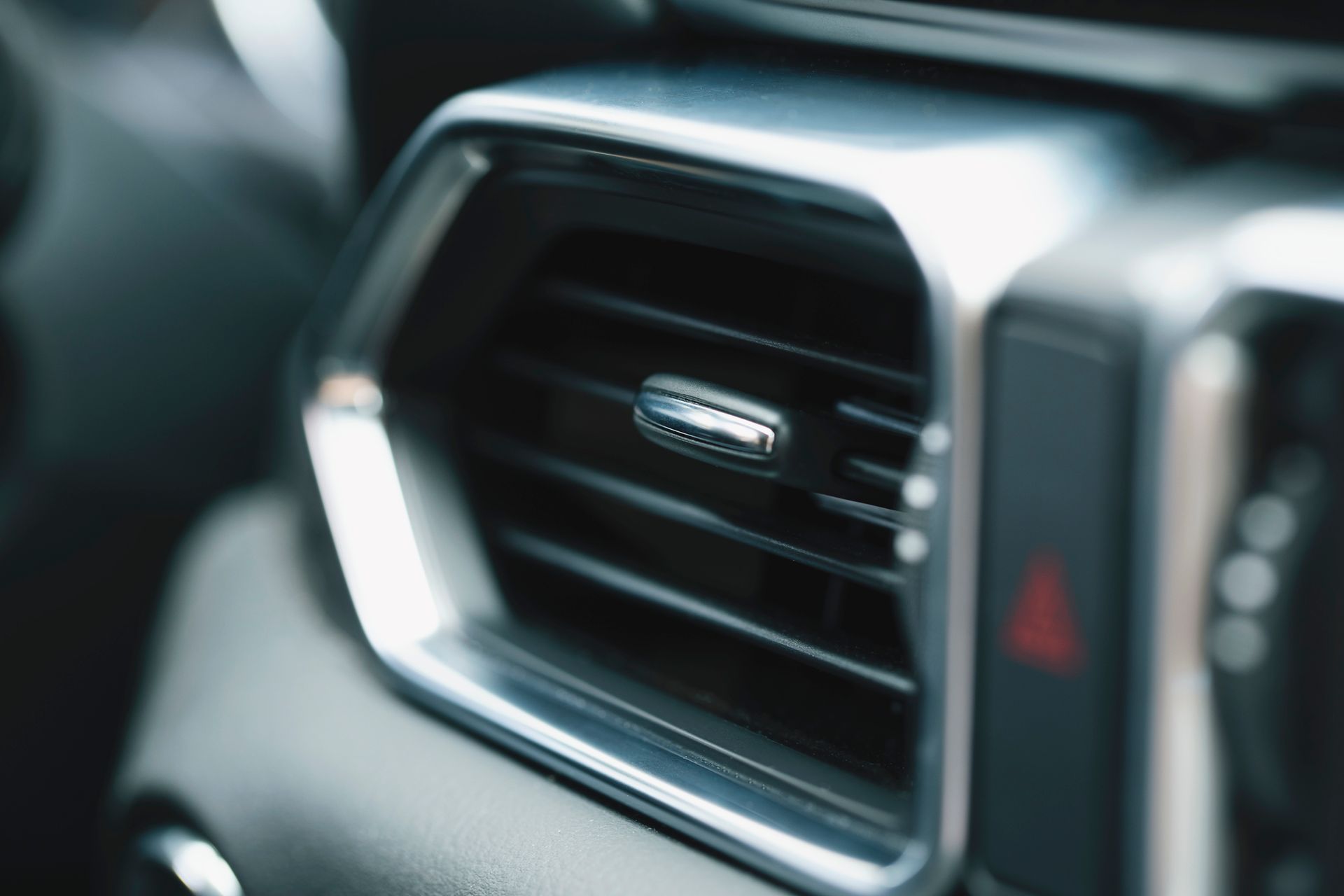 A close up of an air vent in a car.