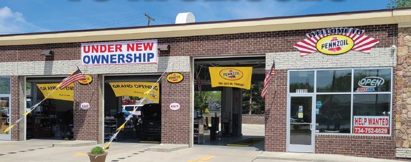 A brick building with a sign that says under new ownership