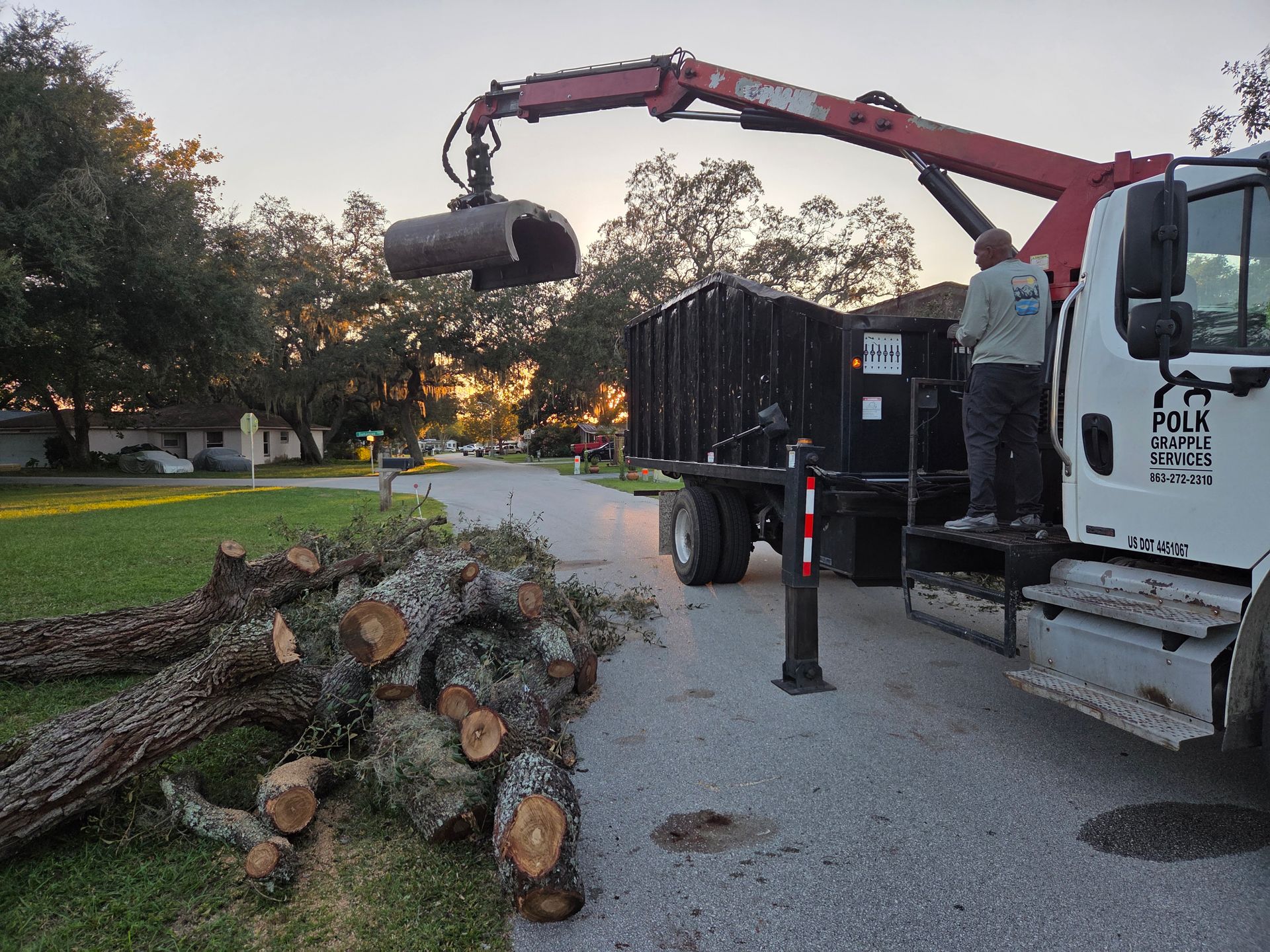 Grapple truck removing yard waste, fallen limbs, and tree debris from a property in Polk County, Florida.