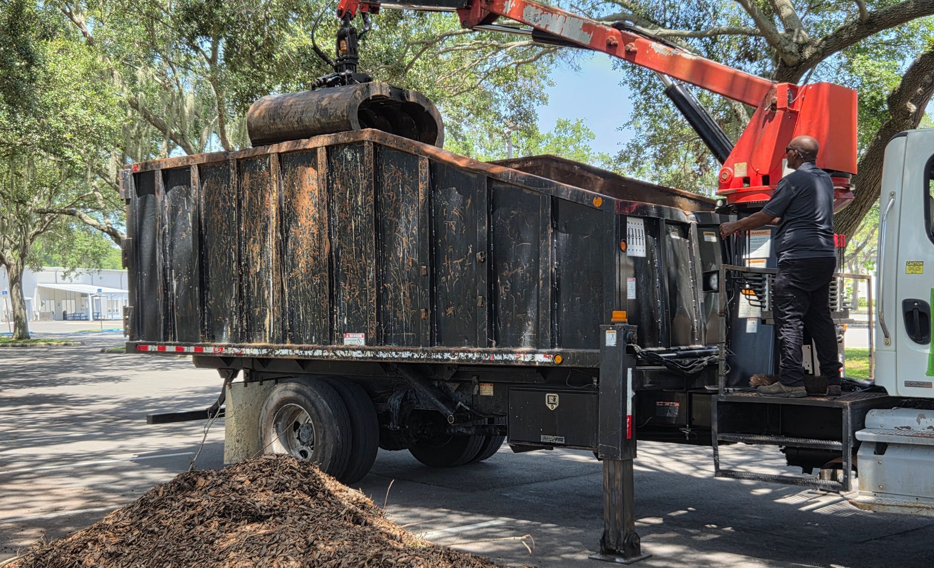 yard debris removal with a grapple truck