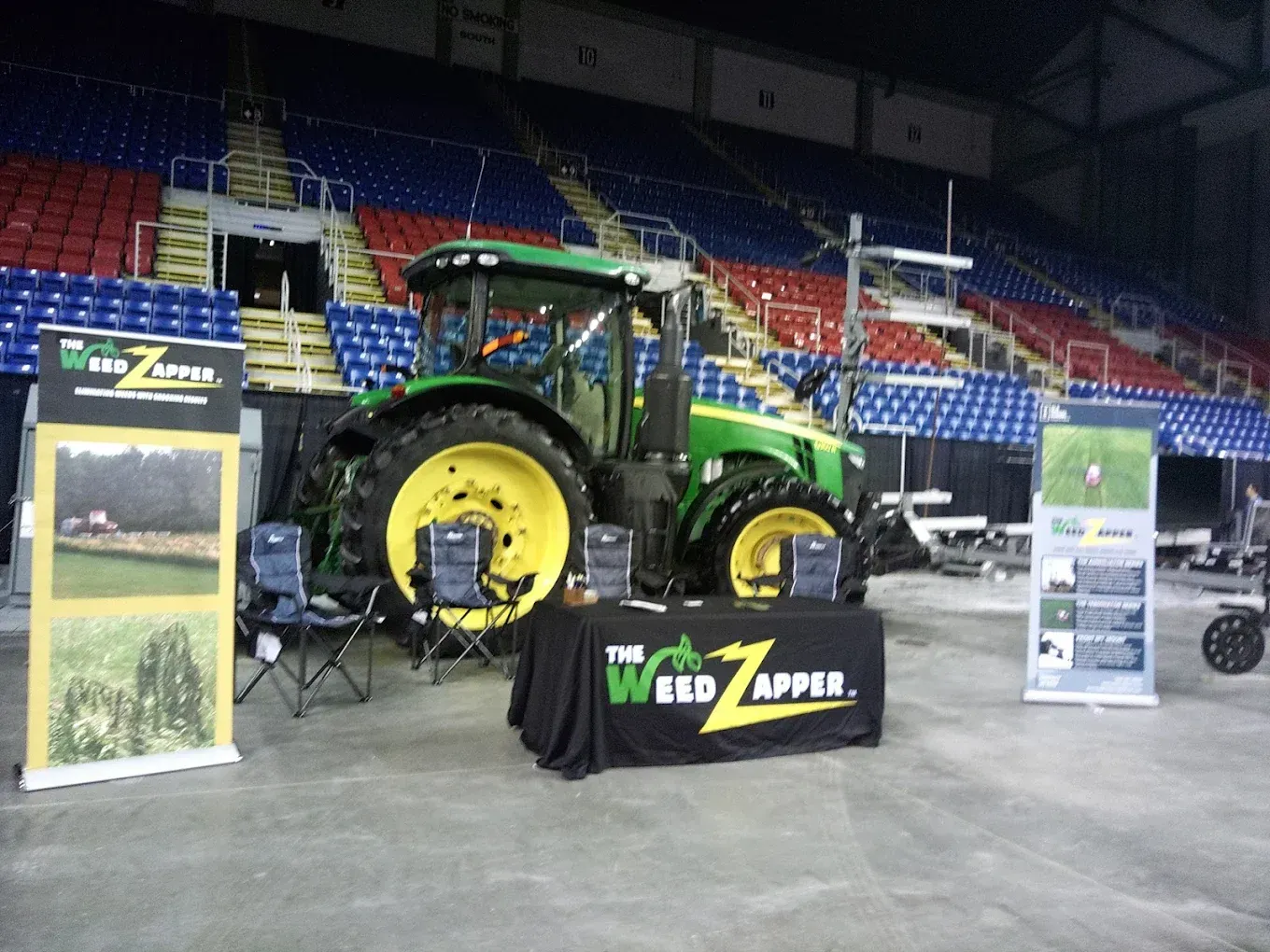 John Deere tractor at a trade show booth; 