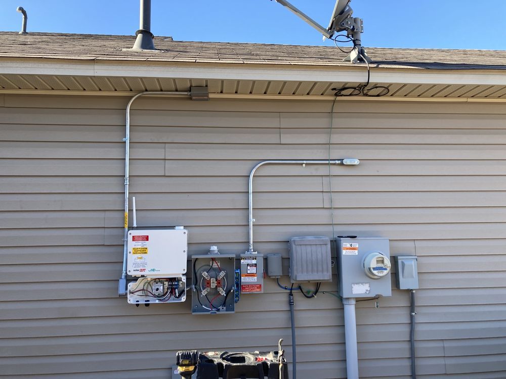 a house with a lot of electrical equipment on the side