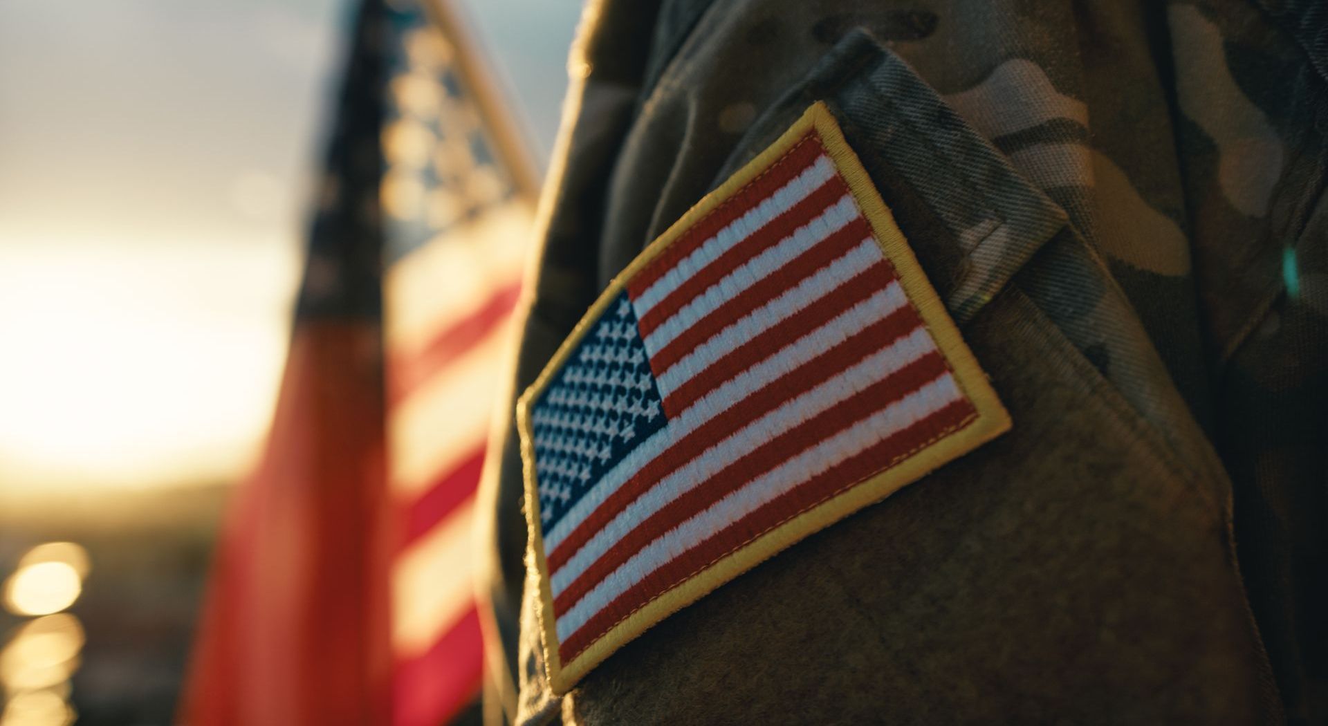 A close up of a soldier 's arm with an american flag patch on it.