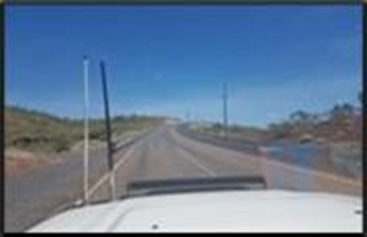 A Car Travels Down a Long Road Under a Clear Blue Sky — Lamont Civil Services Pty Ltd In Townview, QLD