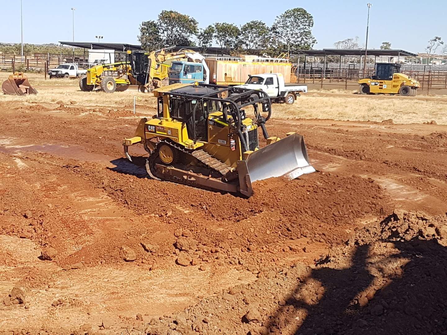 Two yellow excavators on reddish dirt under a blue sky with scattered clouds — Lamont Civil Services Pty Ltd In Townview, QLD