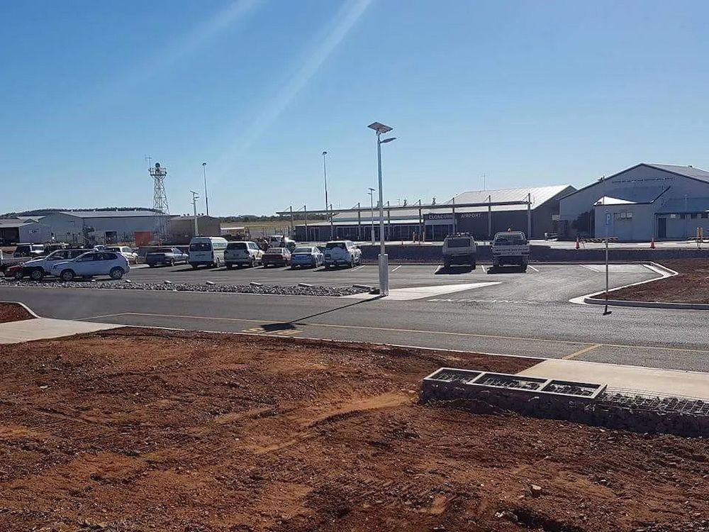 Airport Parking Lot With Cars and Building Under a Bright Blue Sky — Lamont Civil Services Pty Ltd In Townview, QLD