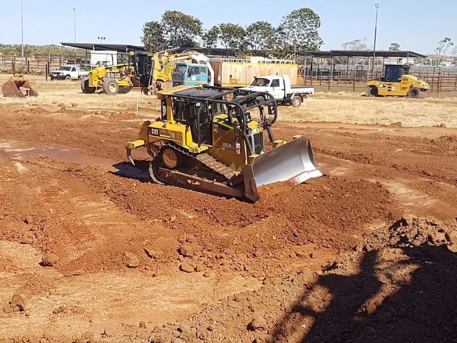 A Yellow Bulldozer Pushing Dirt on a Construction Site — Lamont Civil Services Pty Ltd In Townview, QLD