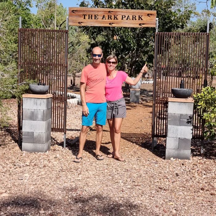 A Man and Woman Standing in Front of a Sign That Says the Ark Park — Nina's Ark Wildlife Sanctuary In Finniss Valley, NT