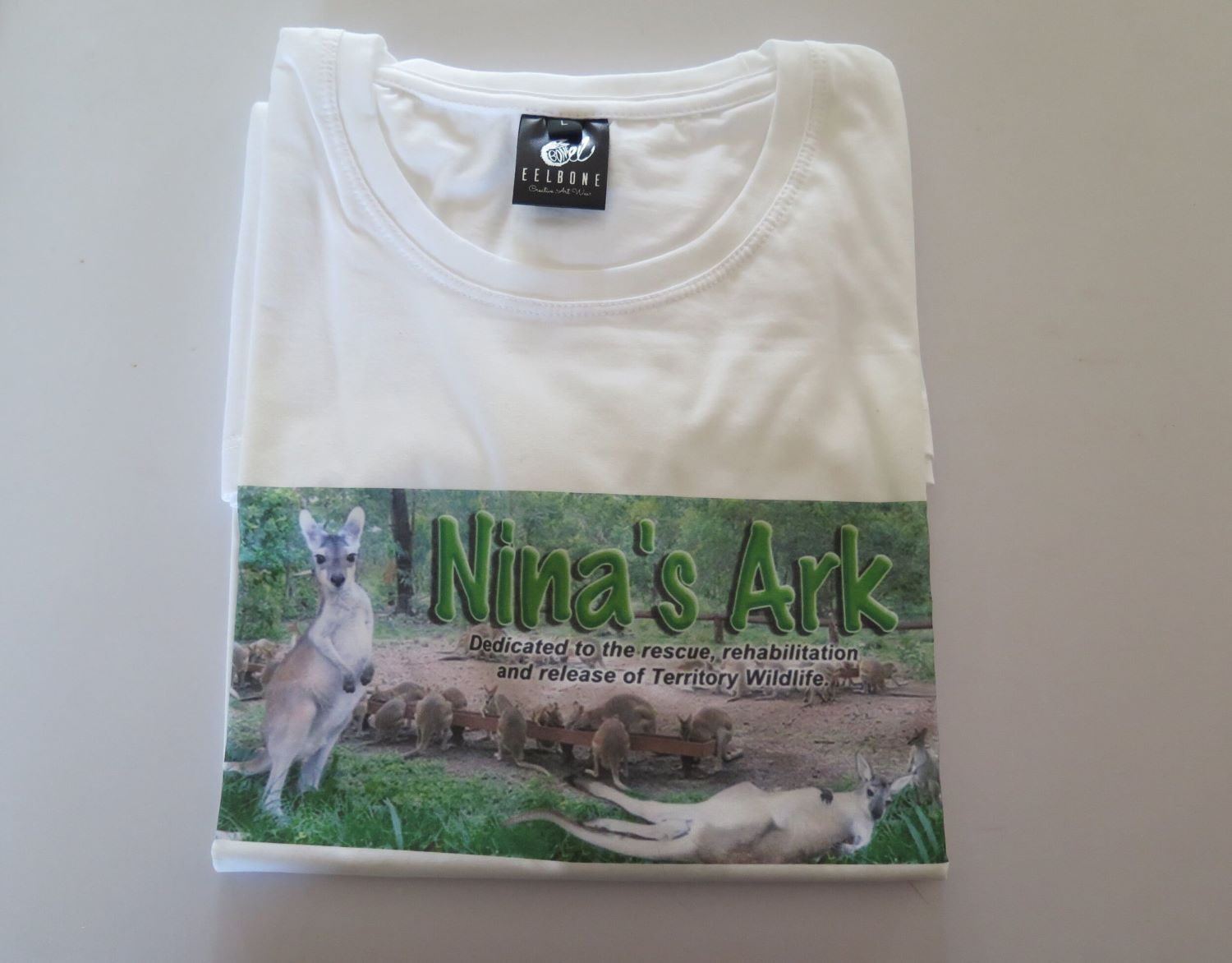 A White T-shirt That Says Nina 's Ark on It — Nina's Ark Wildlife Sanctuary In Finniss Valley, NT