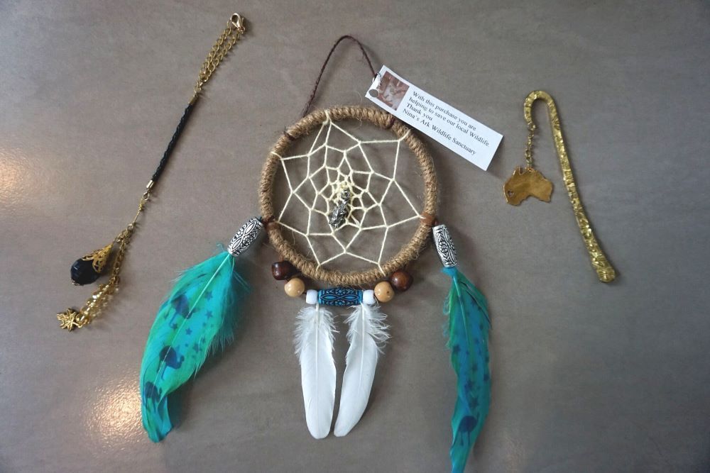 A Dream Catcher With Feathers and a Bookmark on a Table — Nina's Ark Wildlife Sanctuary In Finniss Valley, NT