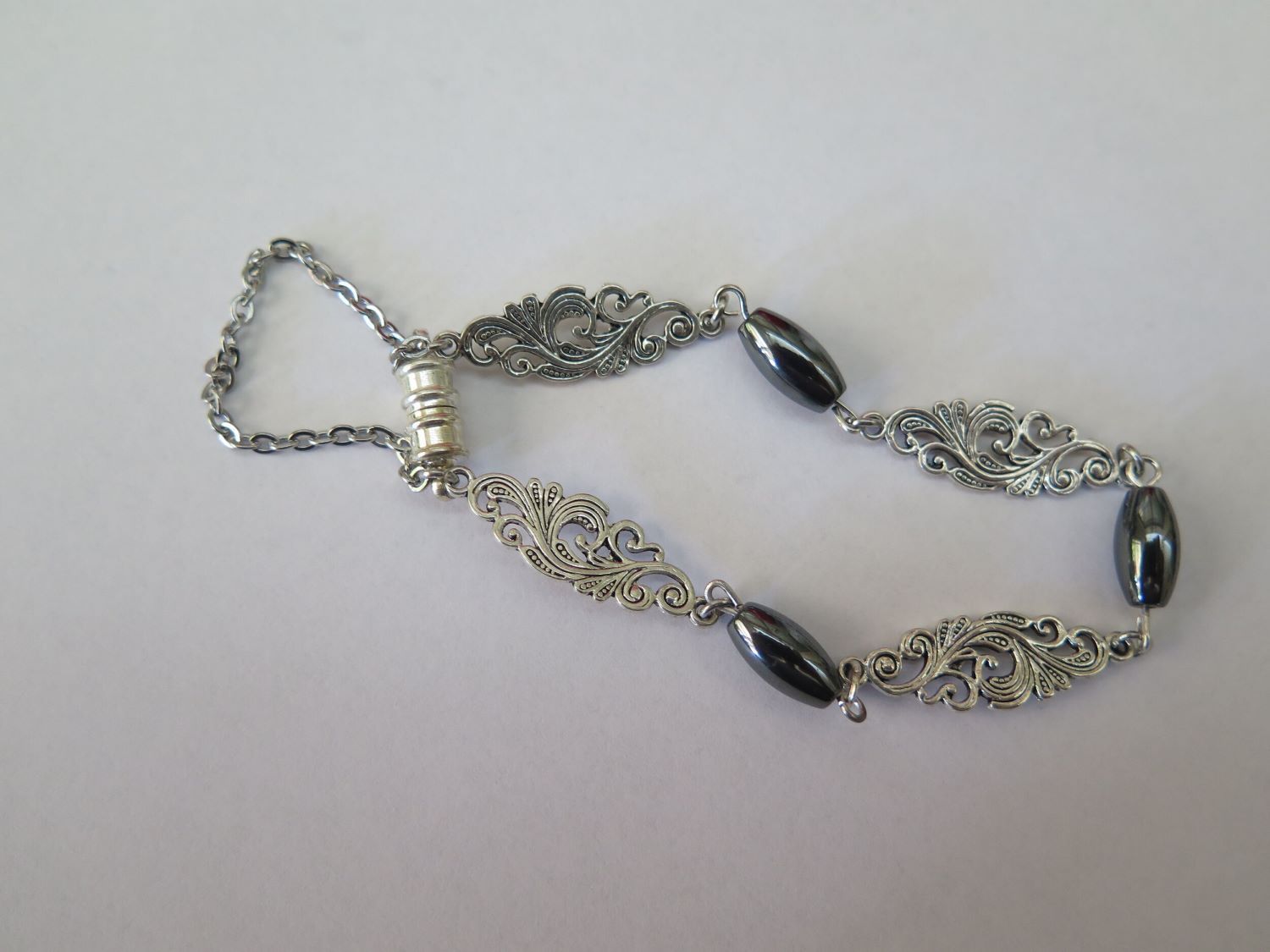 A Silver Bracelet With Black Beads on a White Surface — Nina's Ark Wildlife Sanctuary In Finniss Valley, NT