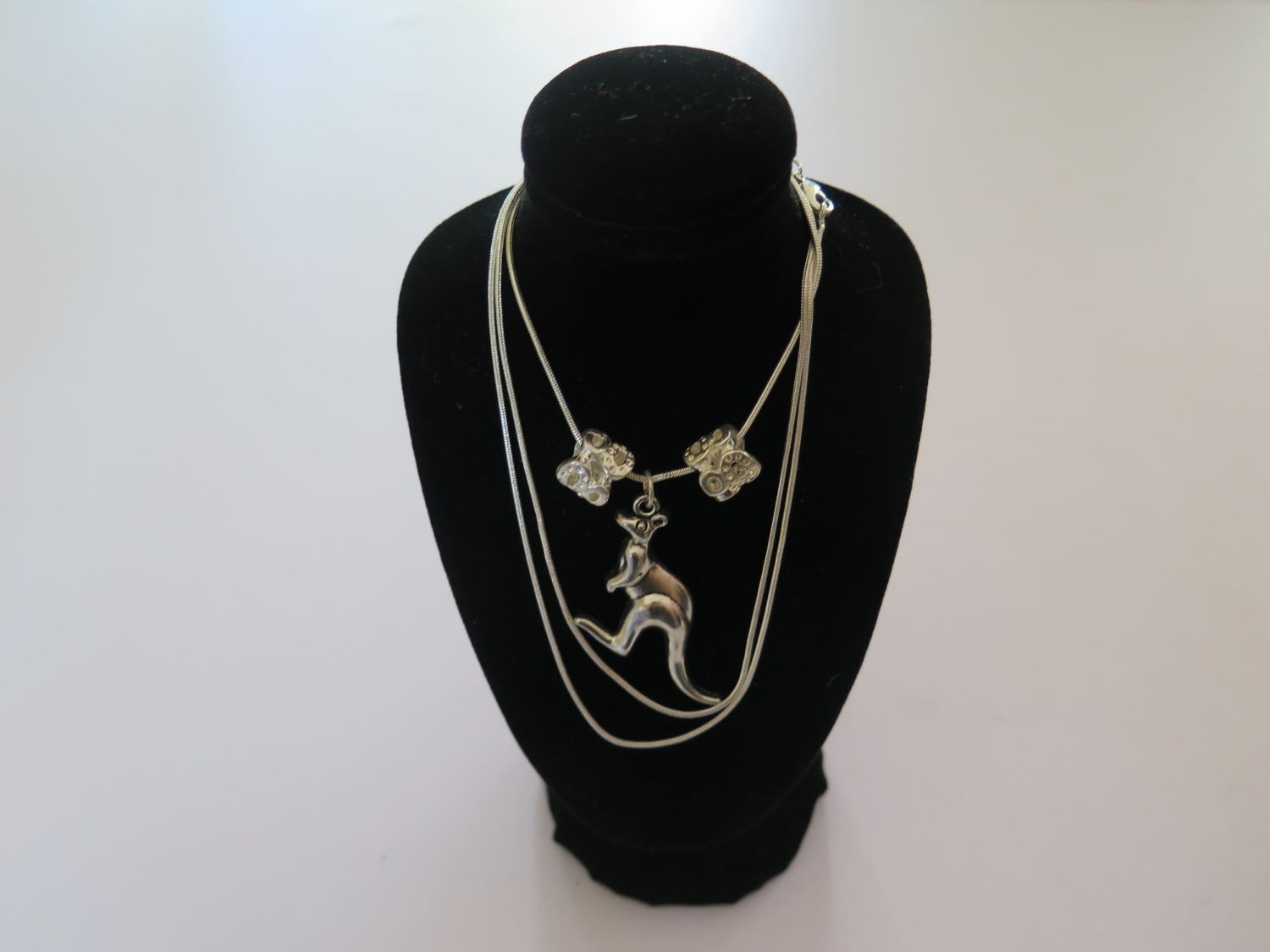 A Necklace With a Kangaroo Pendant is on a Black Mannequin — Nina's Ark Wildlife Sanctuary In Finniss Valley, NT