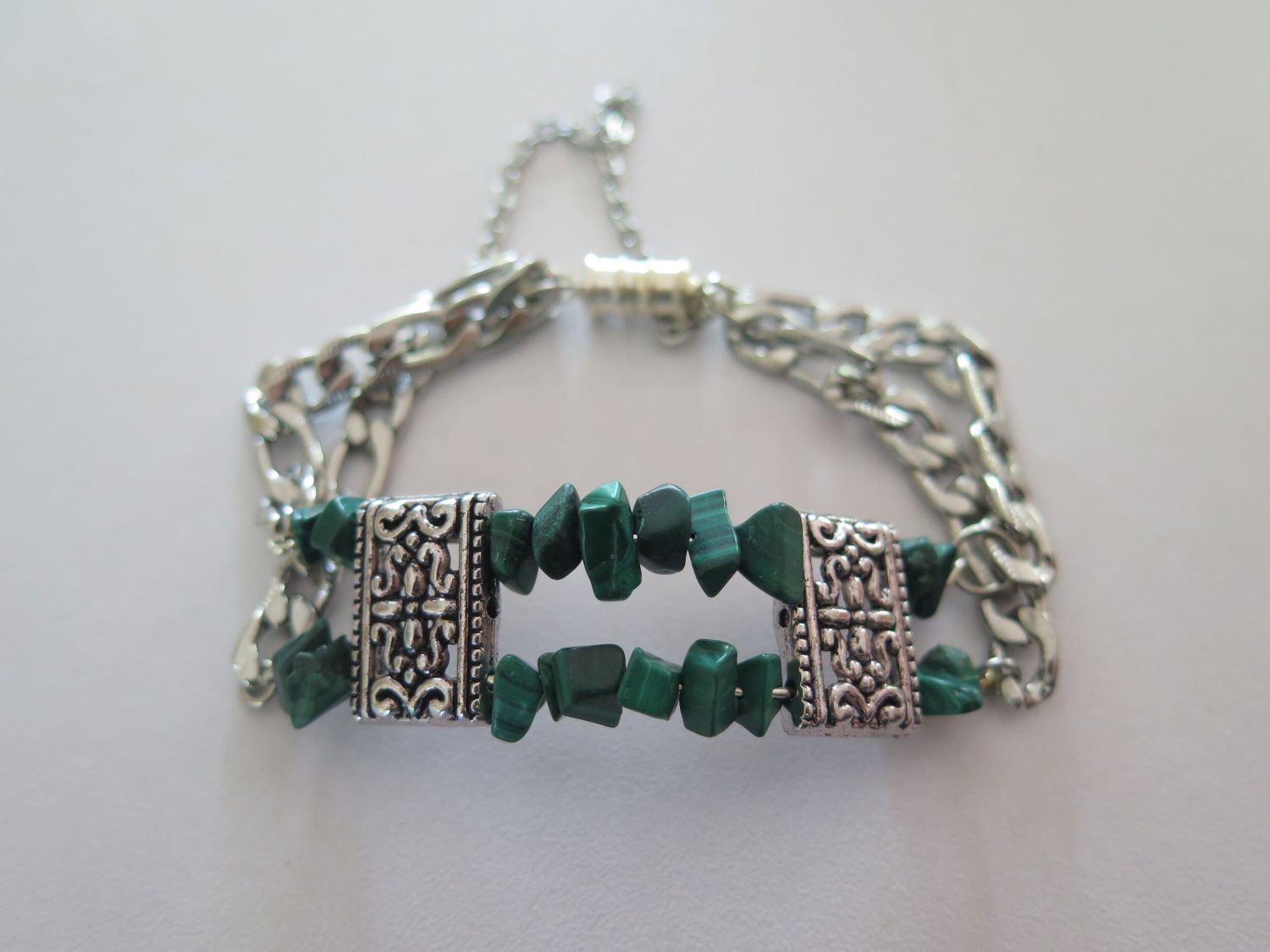 A Silver Chain Bracelet With Green Beads on It — Nina's Ark Wildlife Sanctuary In Finniss Valley, NT