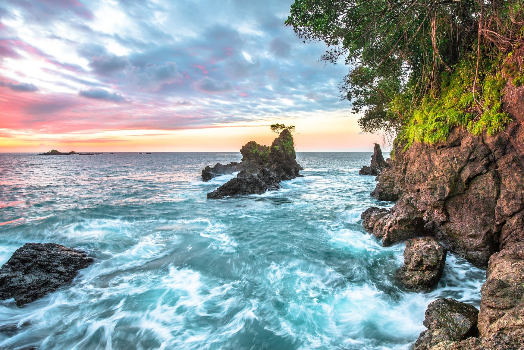 Spacious modern living room with dining area, beige and gray tones, large windows, and a colorful rug.
