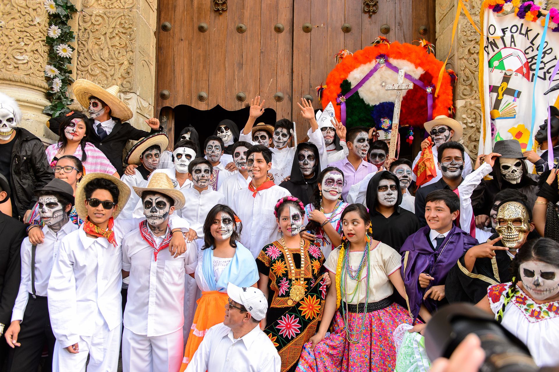 Women dancing in colorful dresses during Day of the Dead festival — Oaxaca Mexico cultural parade.