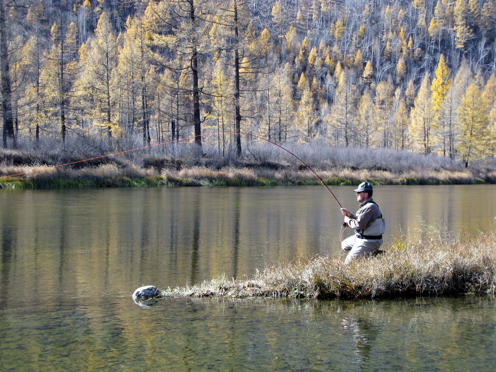 Fly fishing in Alaska wilderness — autumn adventure along pristine lakes and rivers.