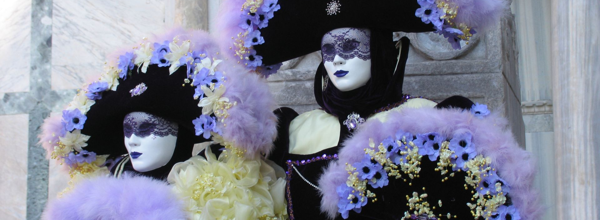 Spacious modern living room with dining area, beige and gray tones, large windows, and a colorful rug.