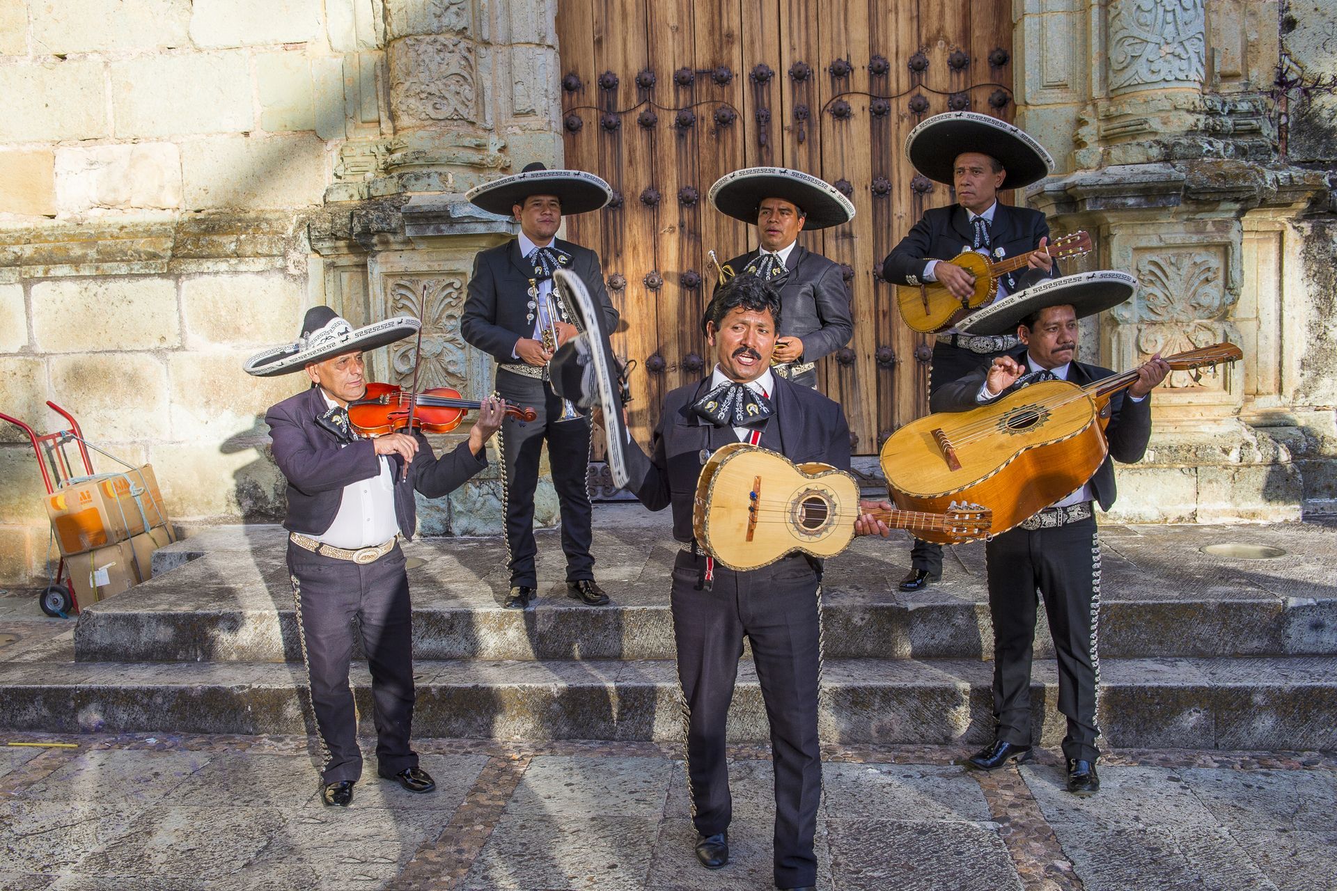Mariachi band performing in colonial plaza — live Mexican music and cultural tradition.