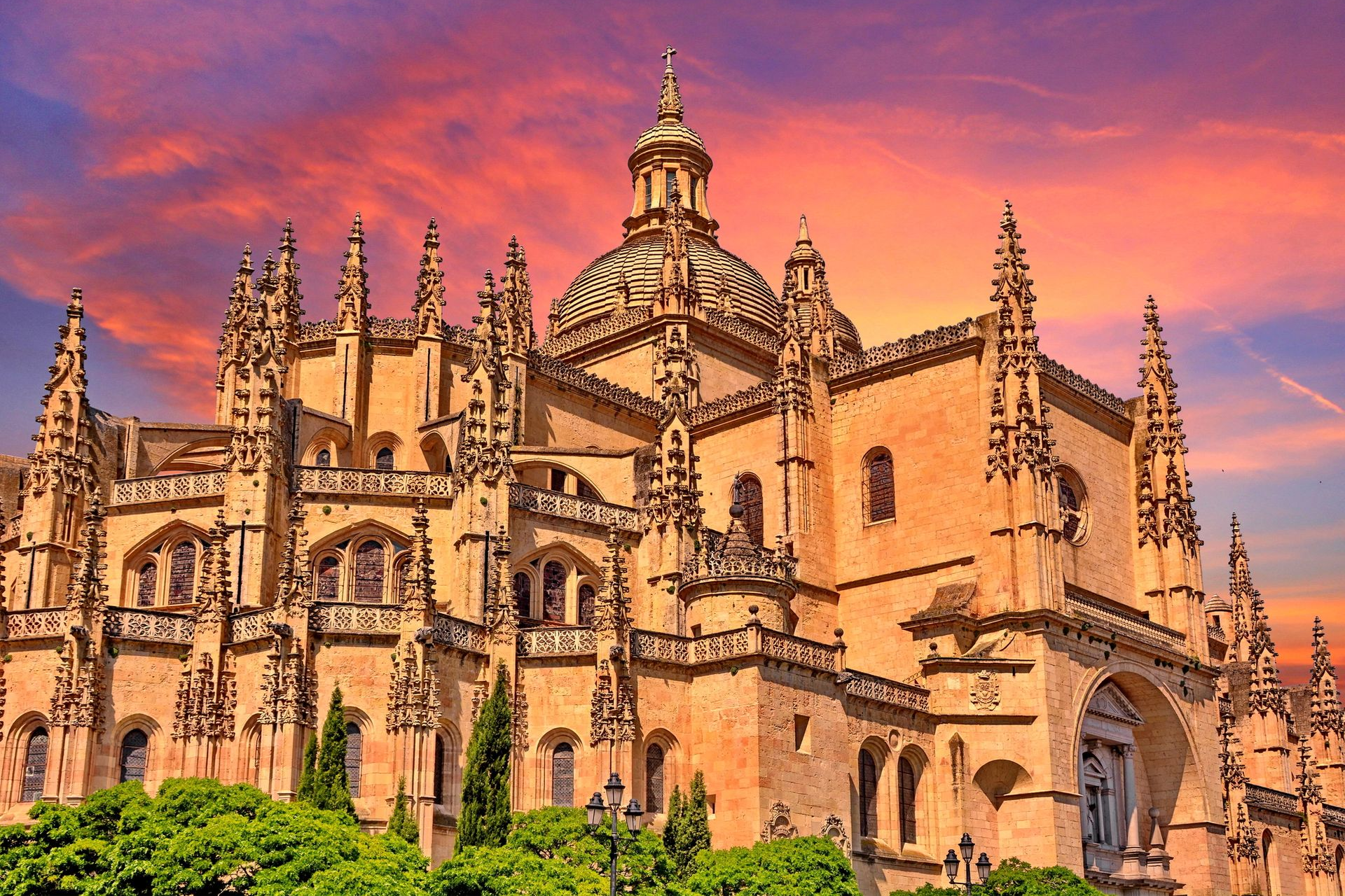 Spacious modern living room with dining area, beige and gray tones, large windows, and a colorful rug.
