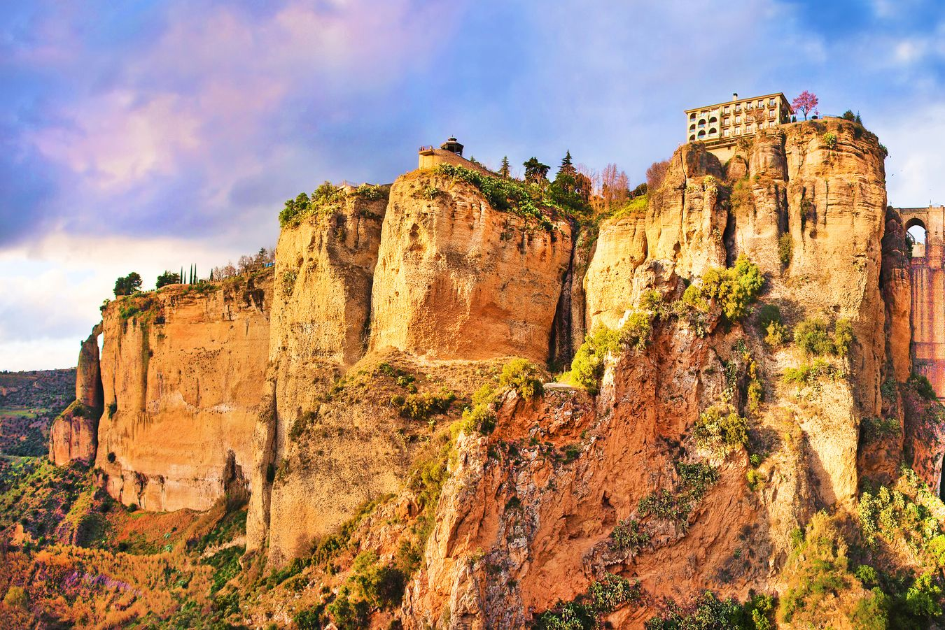Spacious modern living room with dining area, beige and gray tones, large windows, and a colorful rug.