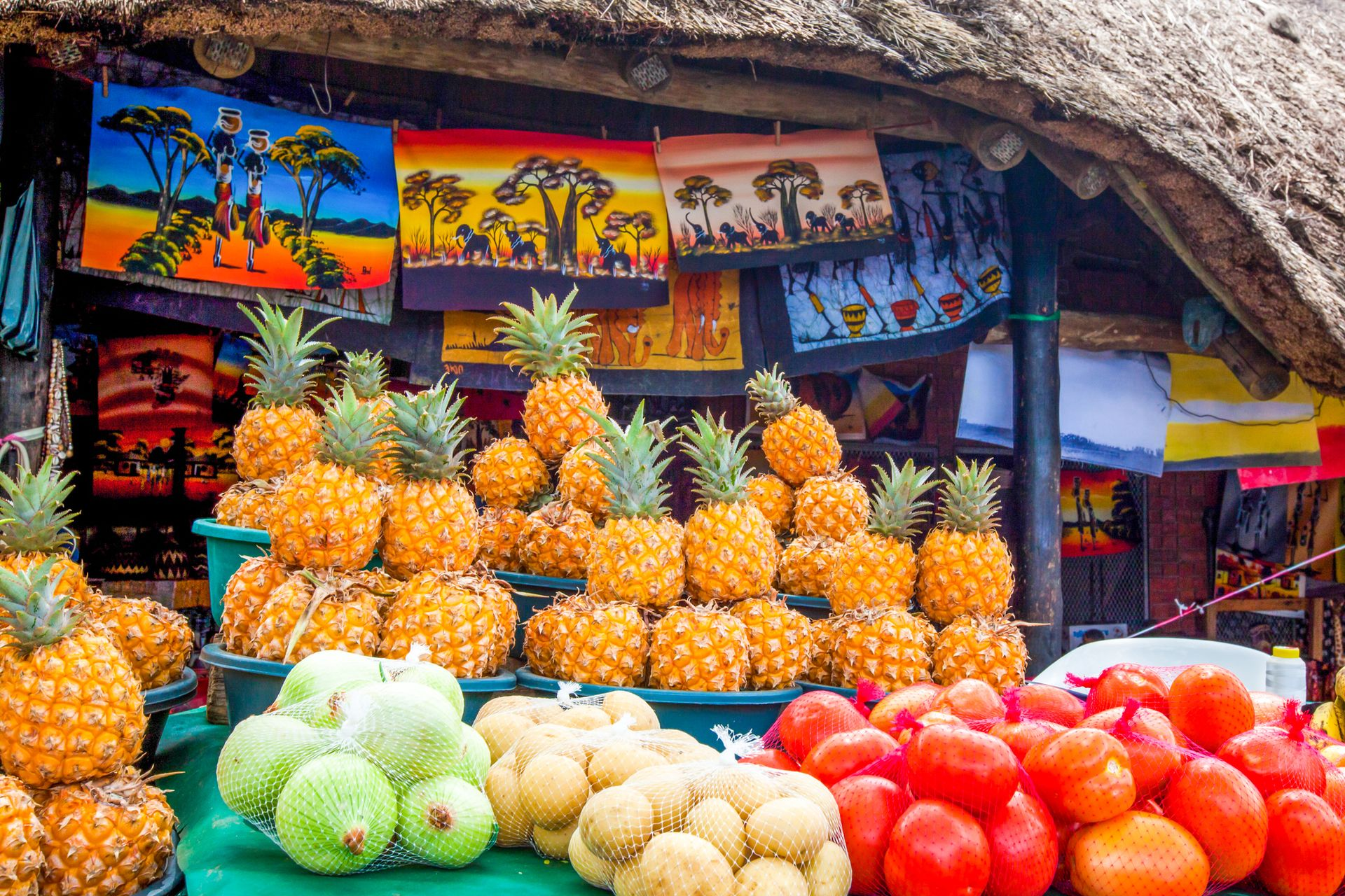 Spacious modern living room with dining area, beige and gray tones, large windows, and a colorful rug.