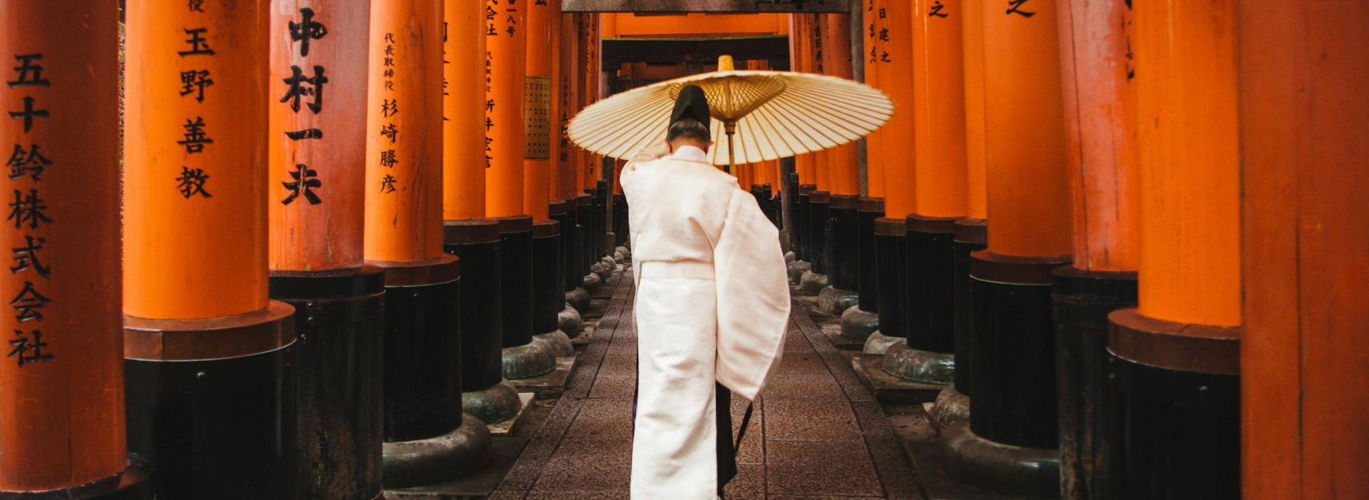 Spacious modern living room with dining area, beige and gray tones, large windows, and a colorful rug.